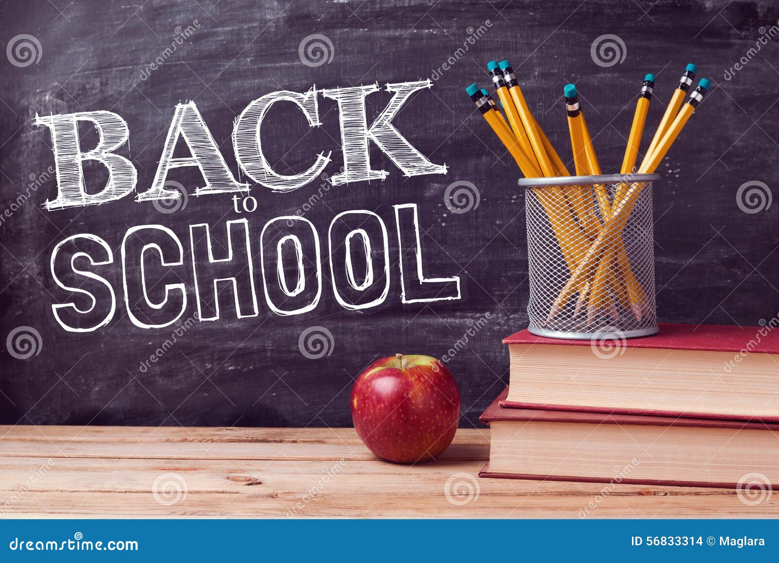 back to school lettering with books, pencils and apple over chalkboard background