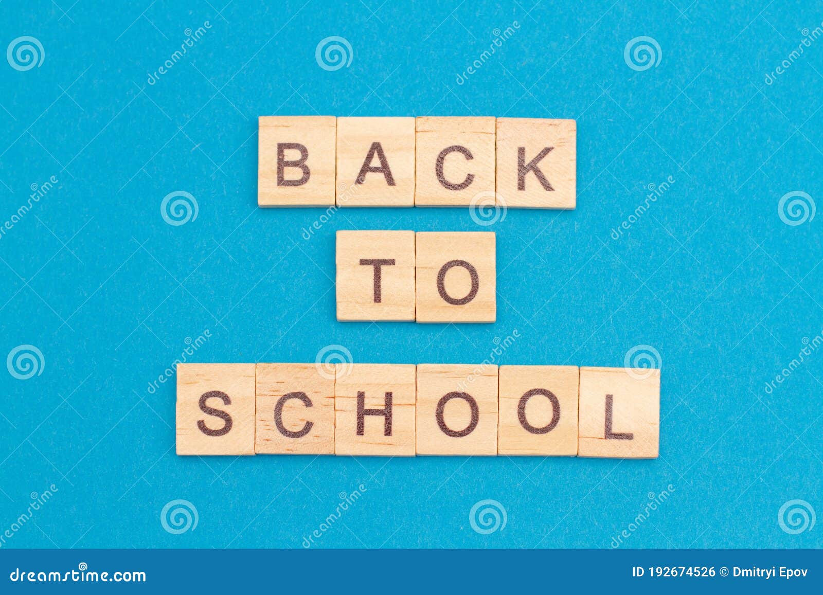back to school word from wooden blocks on a blue background, overhead view. top view, flat lay, from above. new normal after covid