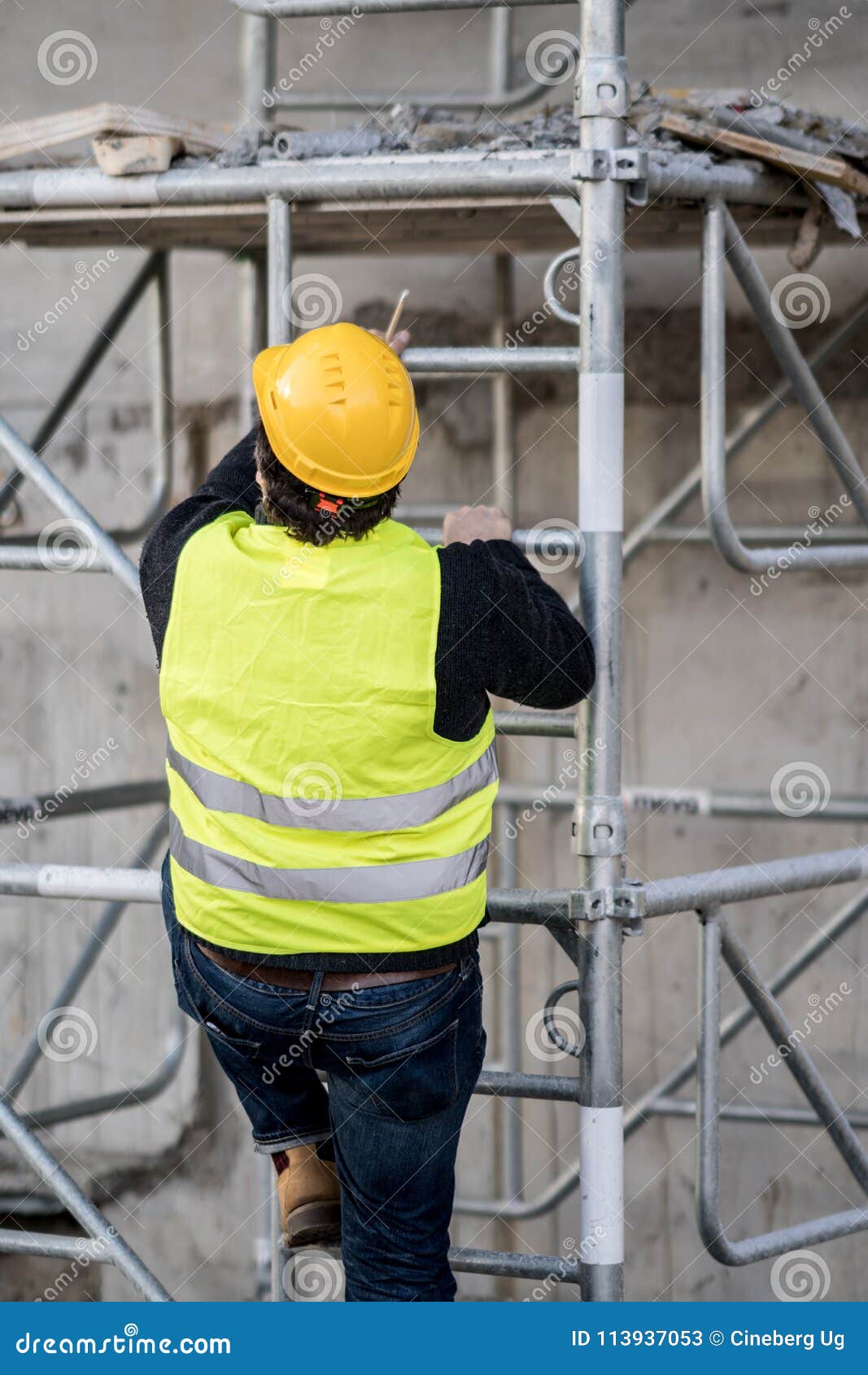 back turned construction worker climbing a ladder