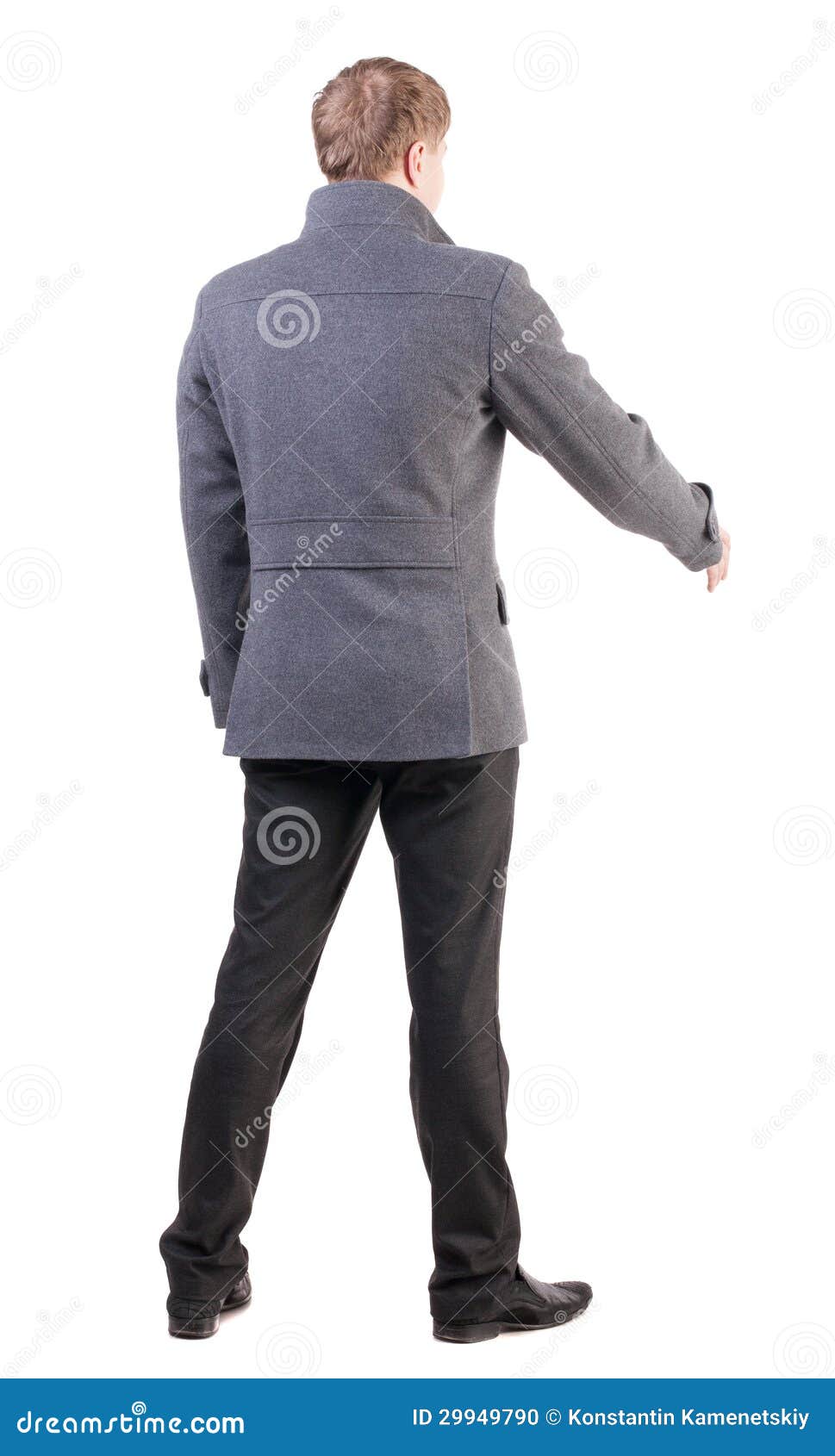 Back View Of Businessman In Coat Reaches Out To Shake Hands. Stock