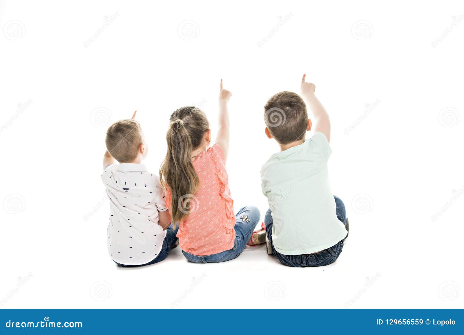 back view of child group sitting on floor looking at wall