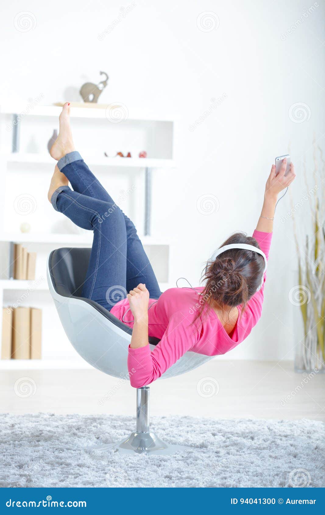 Back View Lady Sat Upside Down In Chair Listening To Headphones