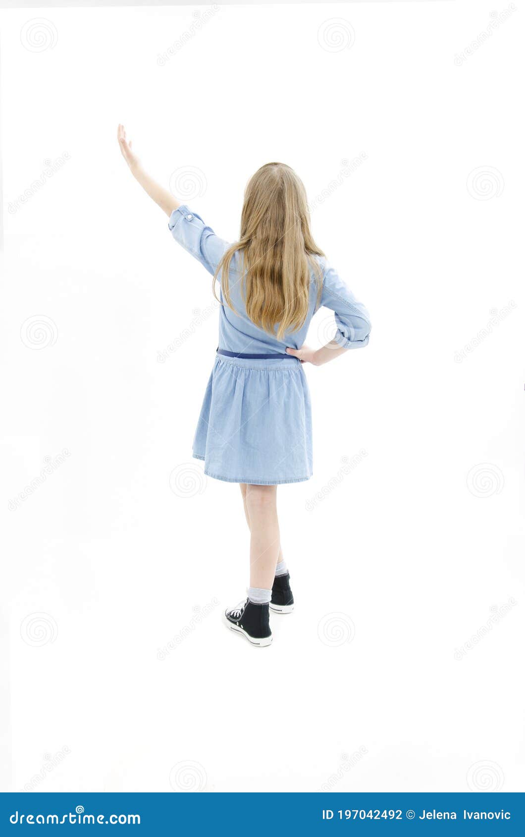 Back View of Little Girl Pointing Up at Wall. Adorable Girl Points Her ...