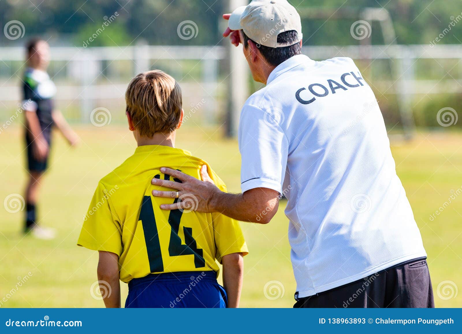 Back View of Male Football Coach in White COACH Shirt at an Outdoor Sport  Field Sending His Young Boy Player in the Game Editorial Stock Photo -  Image of football, coaching: 138963893