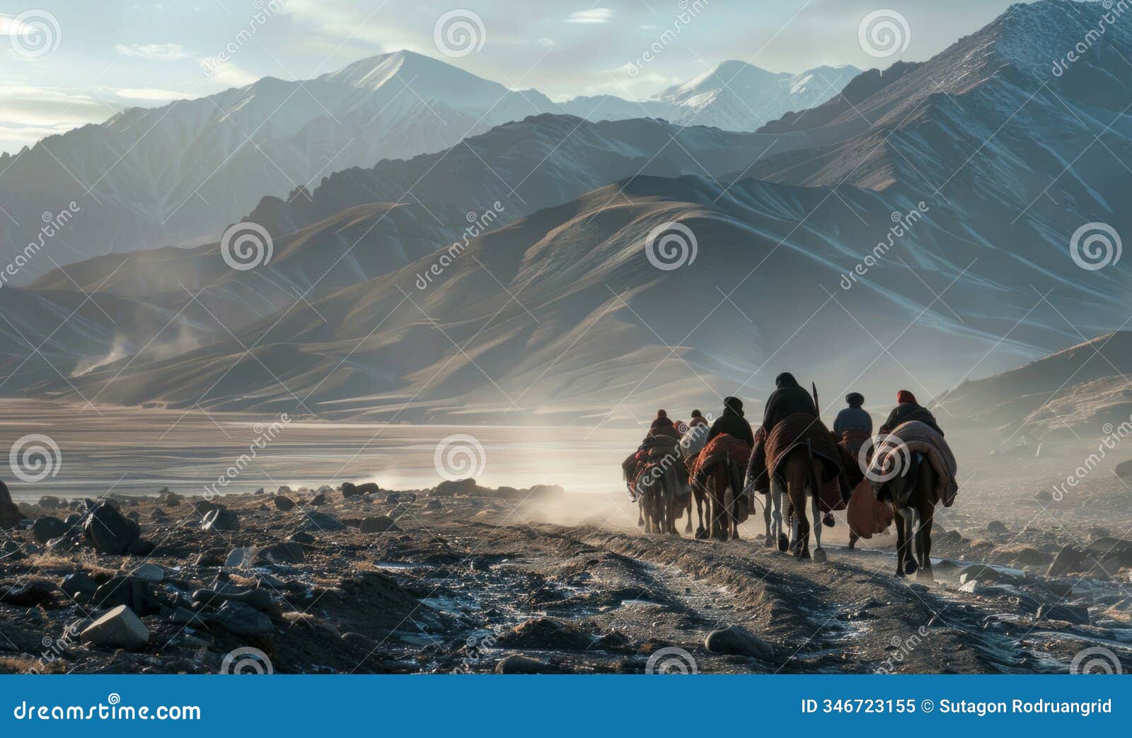back view of mountain nomads people traversing mountain range