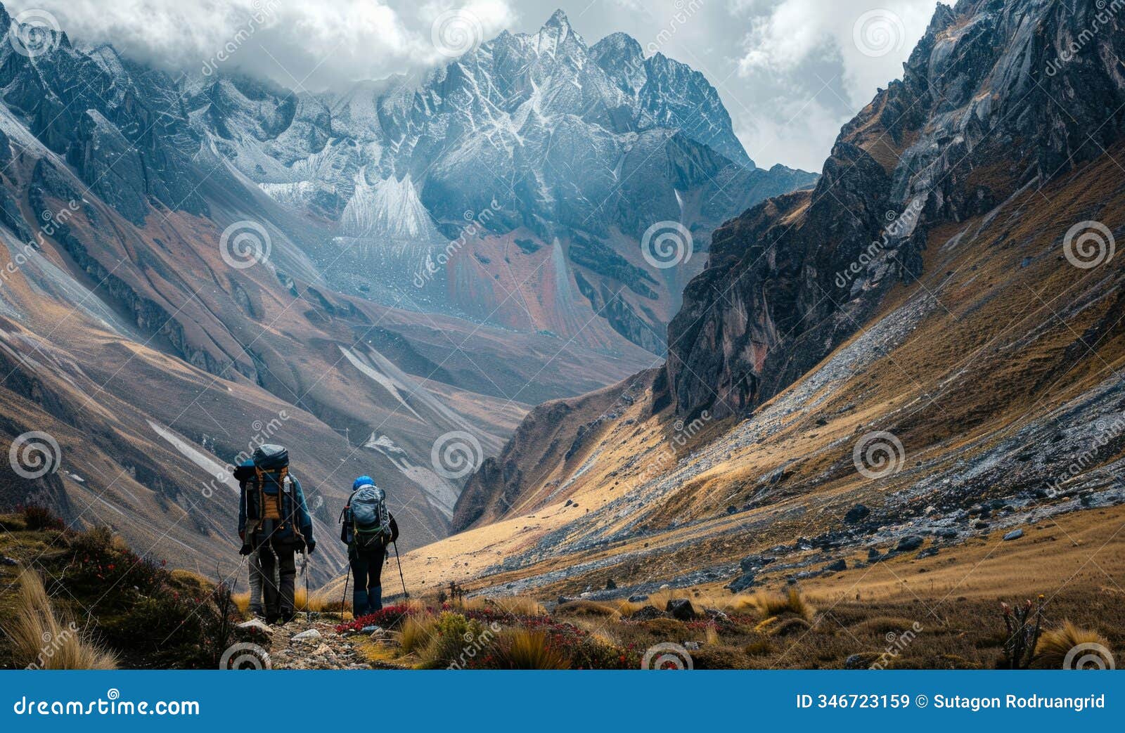 back view of mountain nomads people traversing mountain range