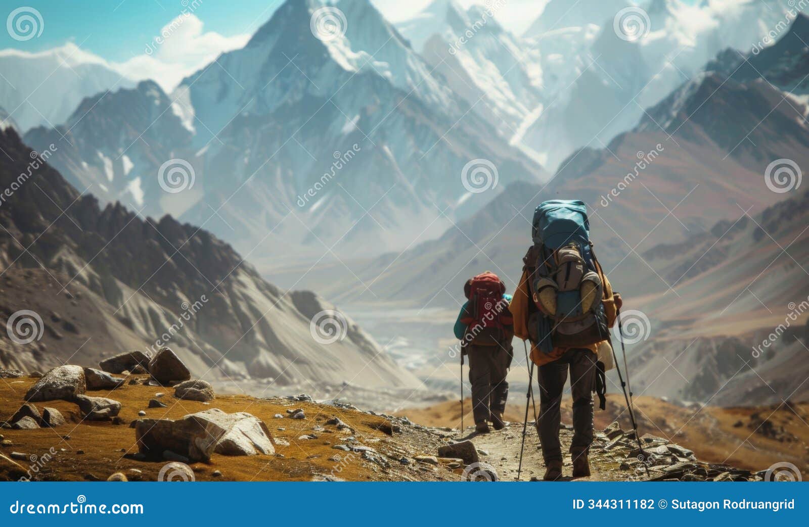 back view of mountain nomads people traversing mountain range