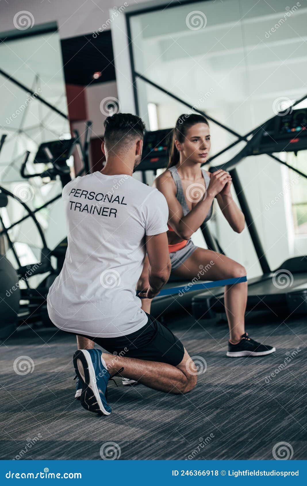 Back View Of Personal Trainer Controlling Stock Photo Image Of