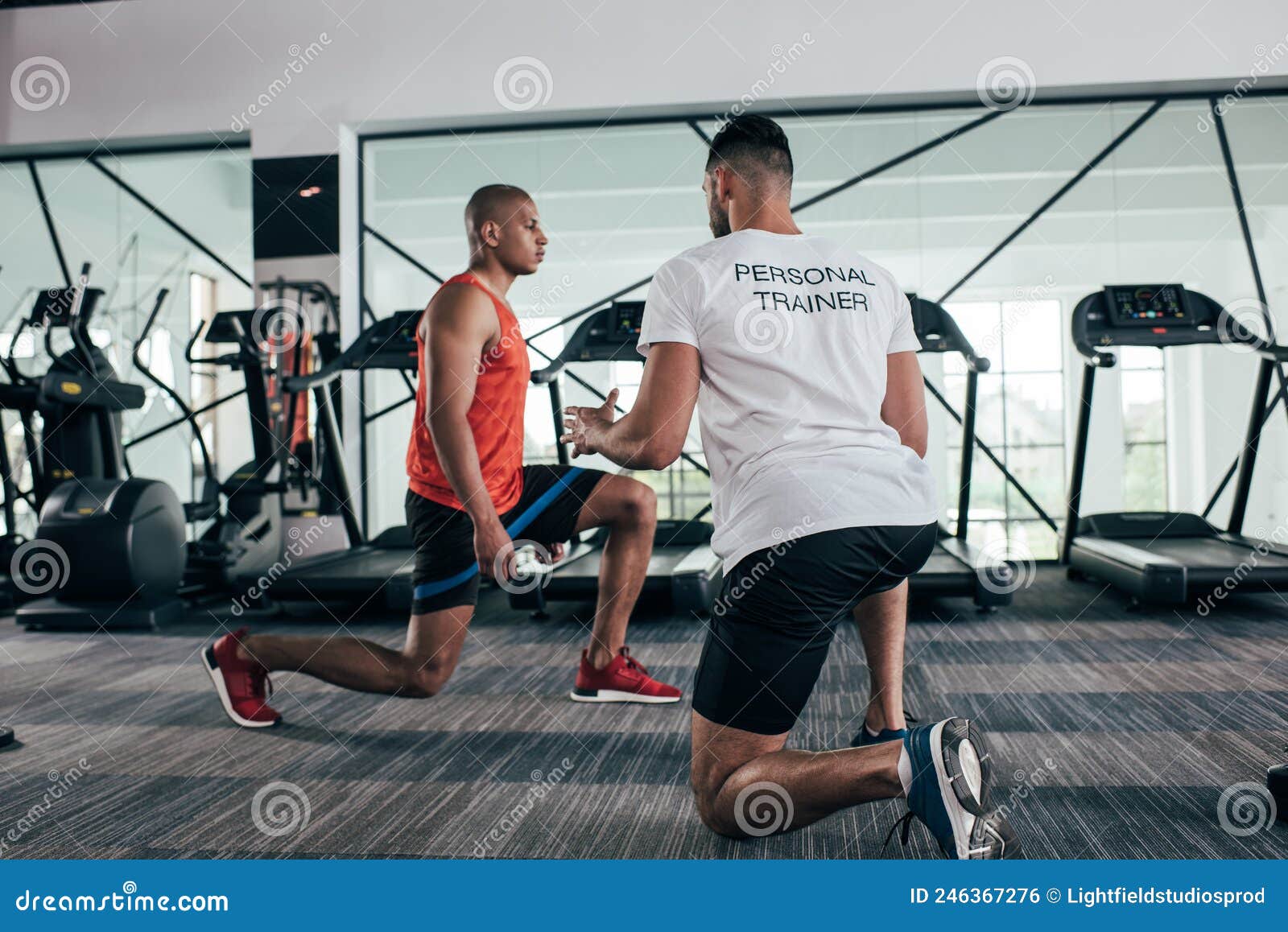 Back View Of Personal Trainer Instructing Stock Photo Image Of Sporty