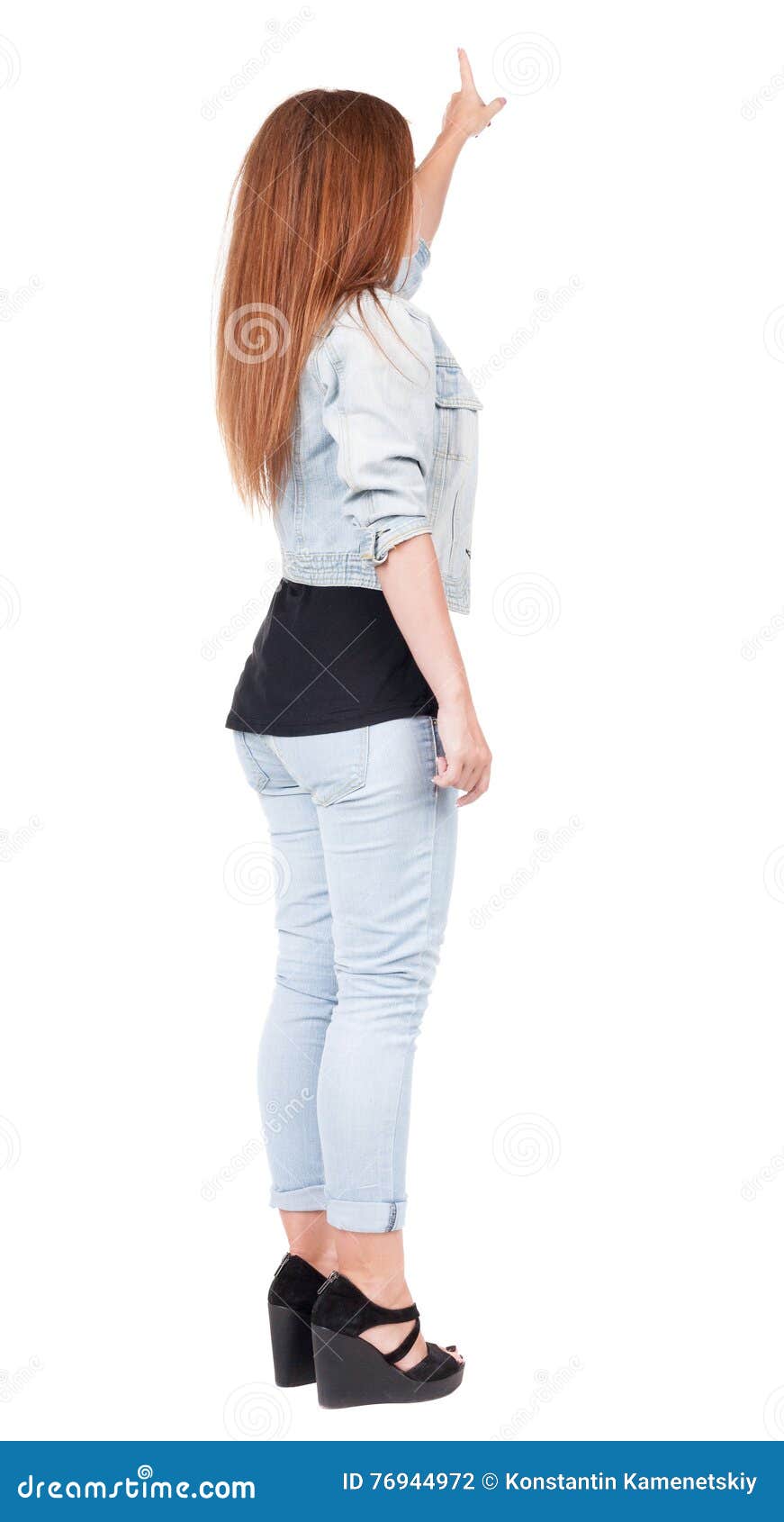 Back View of Pointing Woman. Beautiful Redhead Girl in Jeans Stock ...