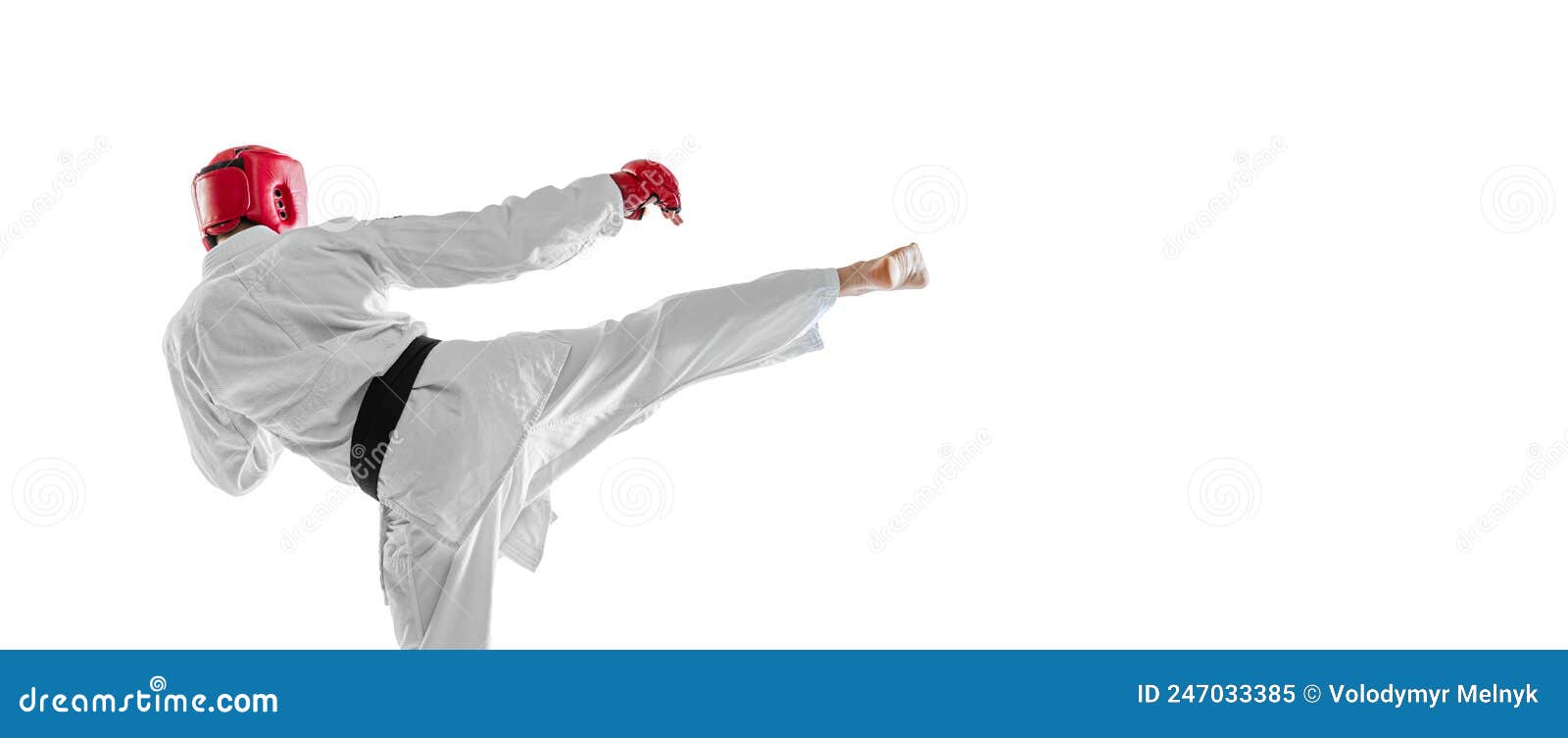 back view. portrait of young sportive man wearing white dobok, helmet and gloves practicing  over white