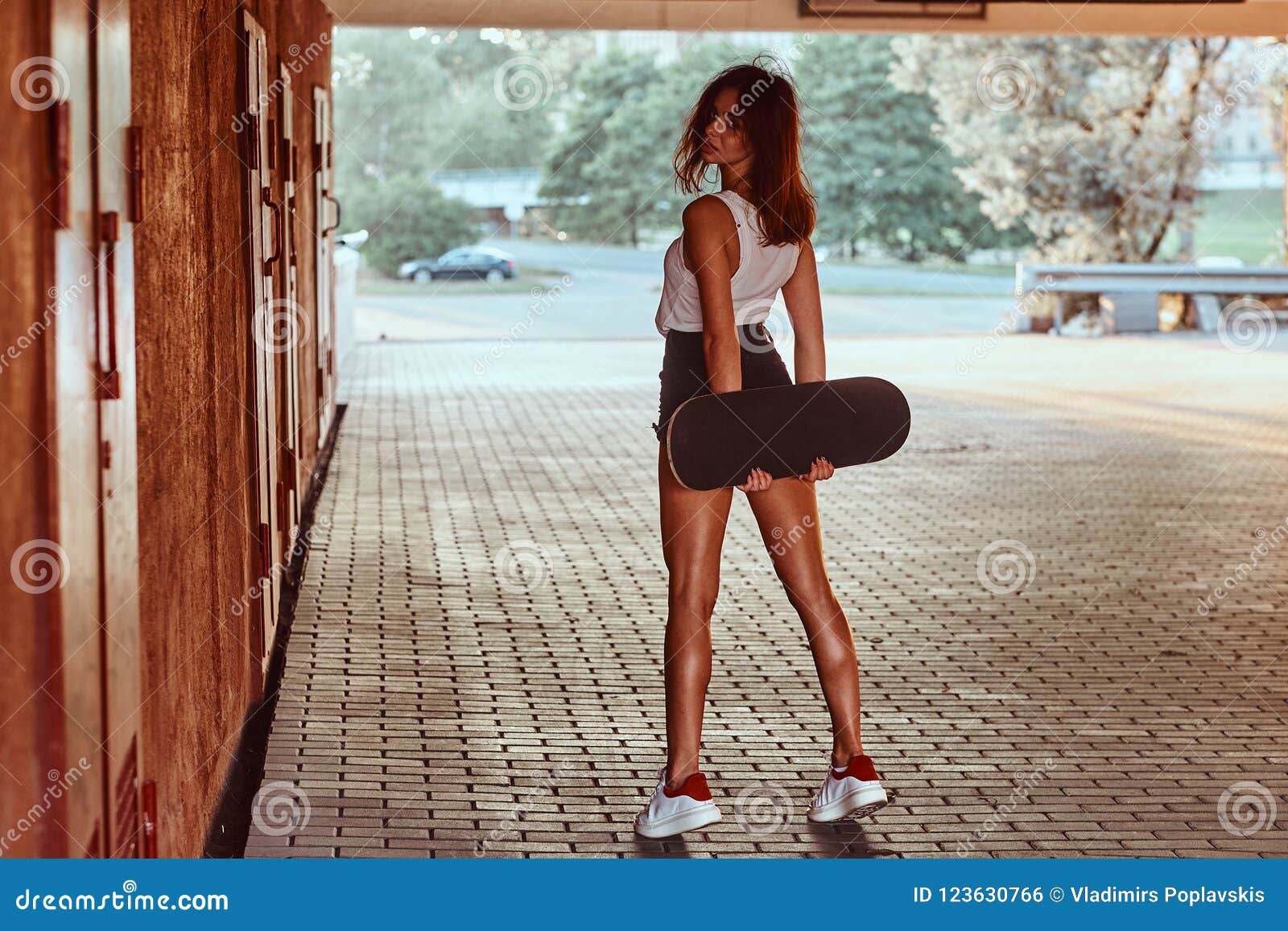 Back View of a Sensual Young Skater Girl Dressed in Shorts and T-shirt ...
