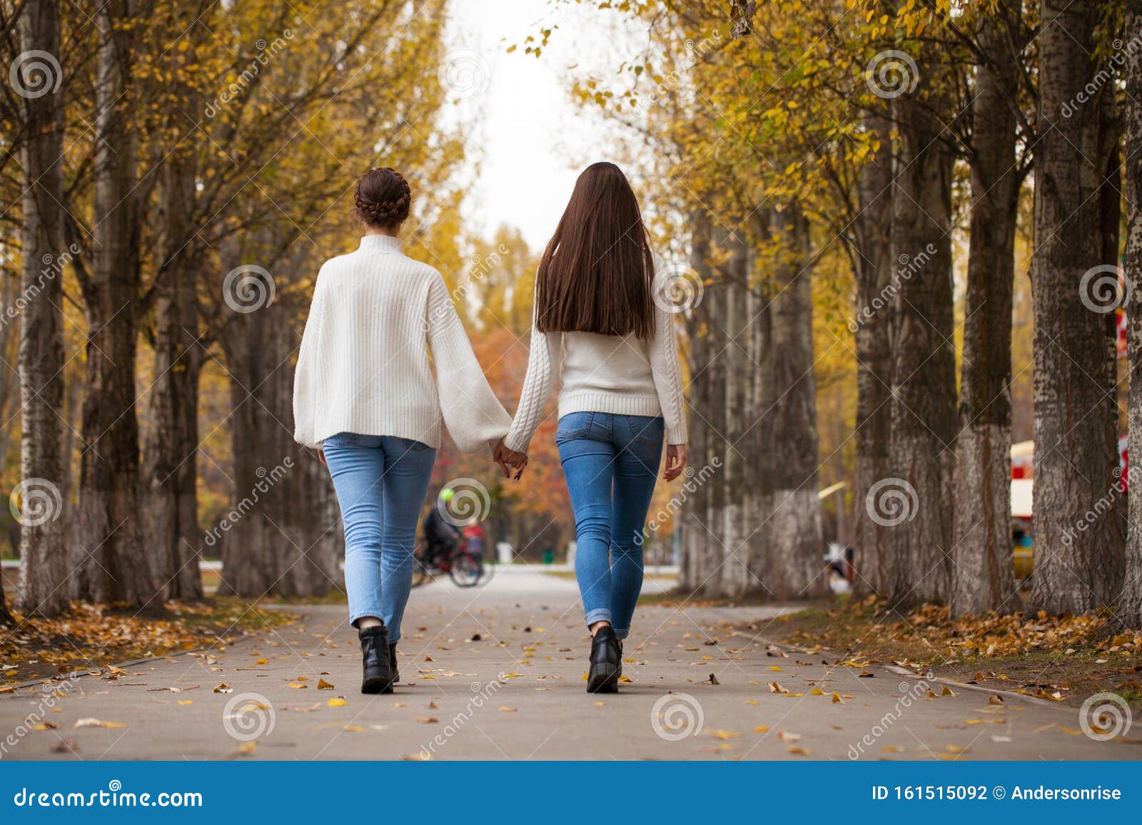 Two Girlfriends in a White Woolen Sweater and Blue Jeans Stock Photo ...