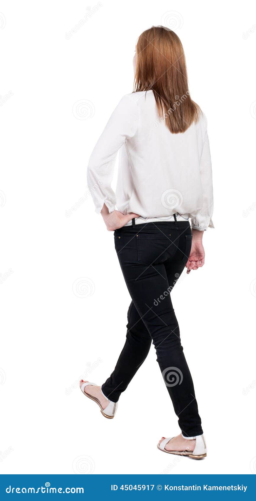back view of walking woman in jeans. beautiful blonde girl in m