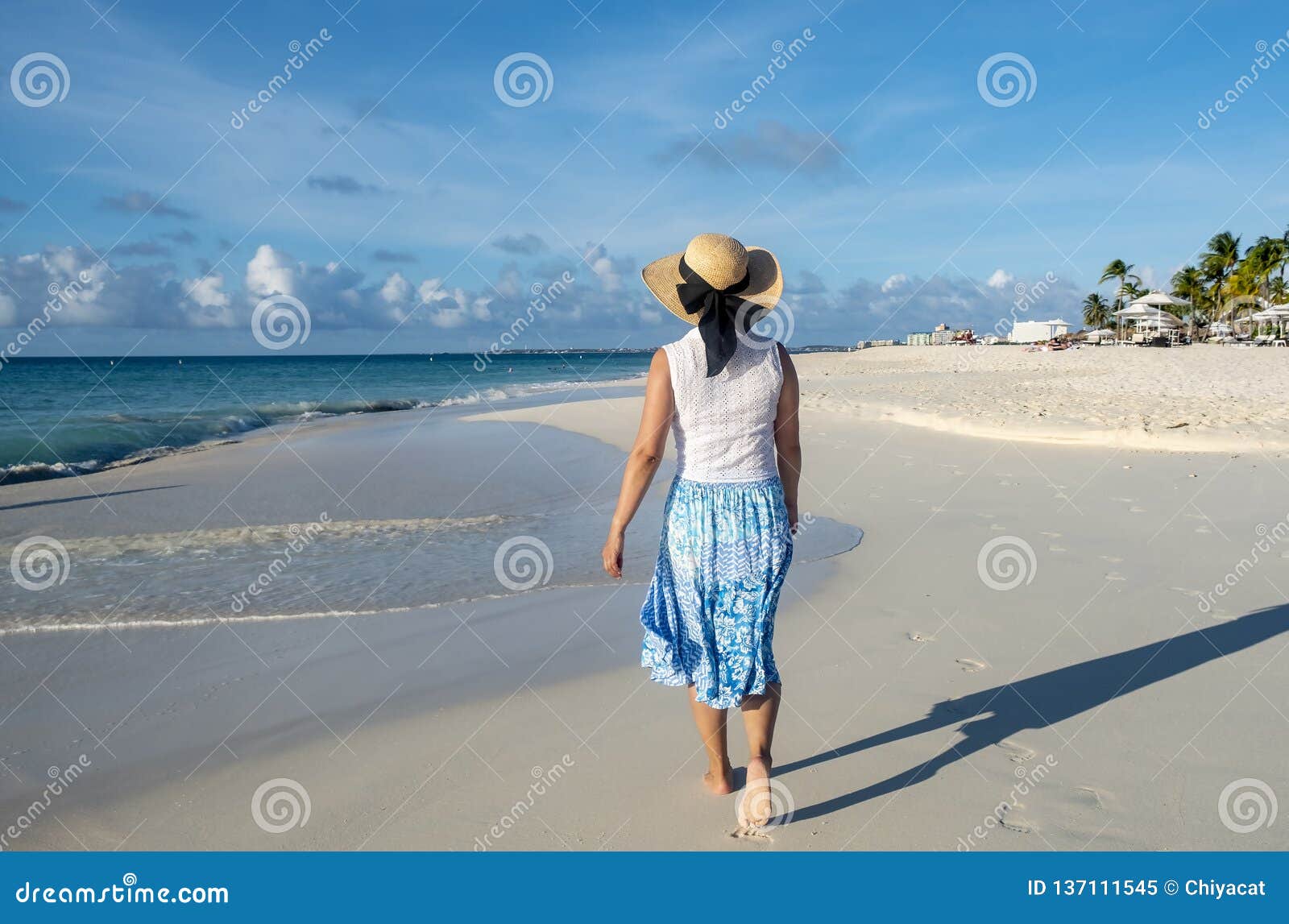 Close Up Of Barefoot Woman Walking On The Beach During 