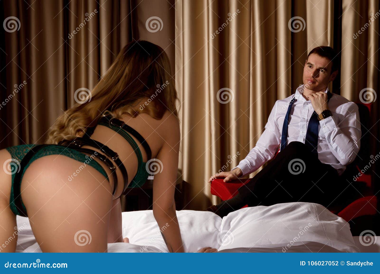 Back View of Woman in Underwear Kneels on on a Bed and Trying To