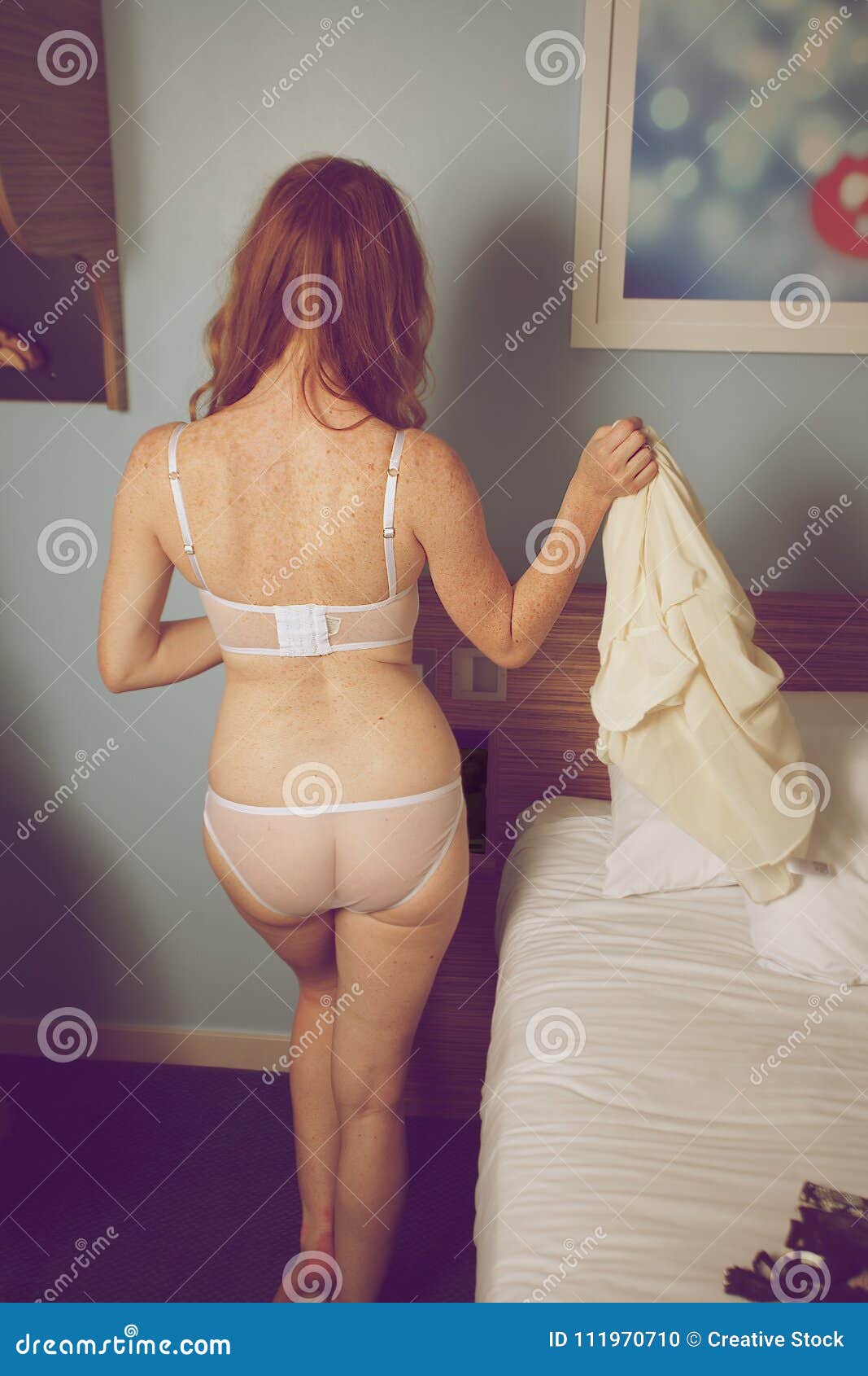 Woman gets undressed stock photo