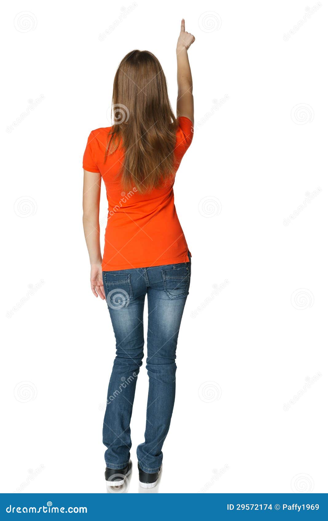 Back View Of Young Casual Female In Full Length Pointing At Blank Copy