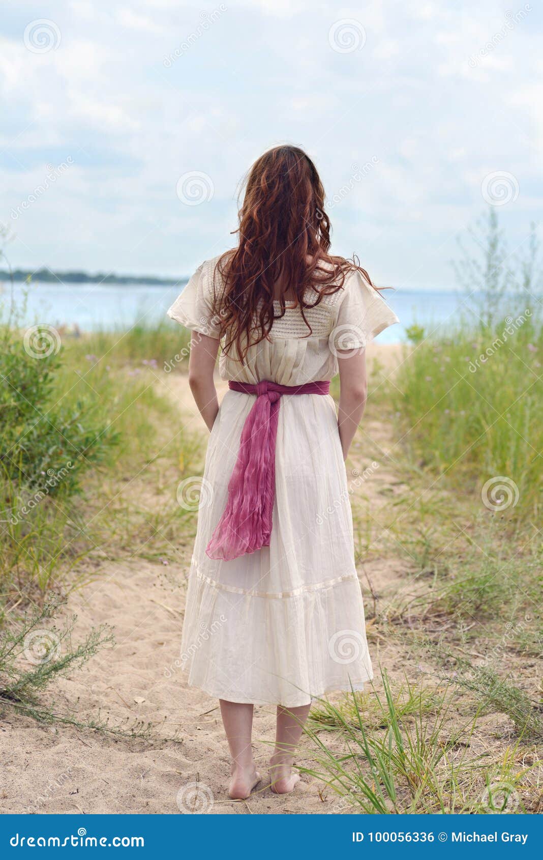 Back of Vintage Redhead Woman at the Beach with Bare Feet Stock Photo ...