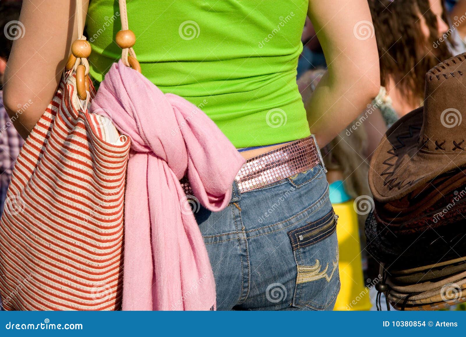 The Back of a Young Girl in Bright Clothes at a Fa Stock Photo Image