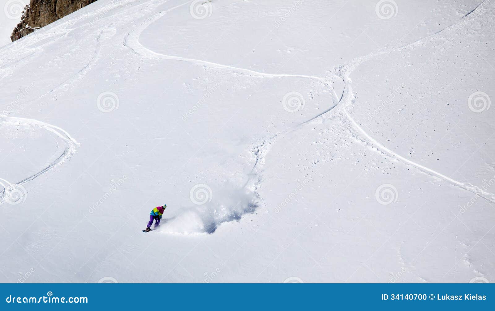 backcountry snowboarder riding fresh powder
