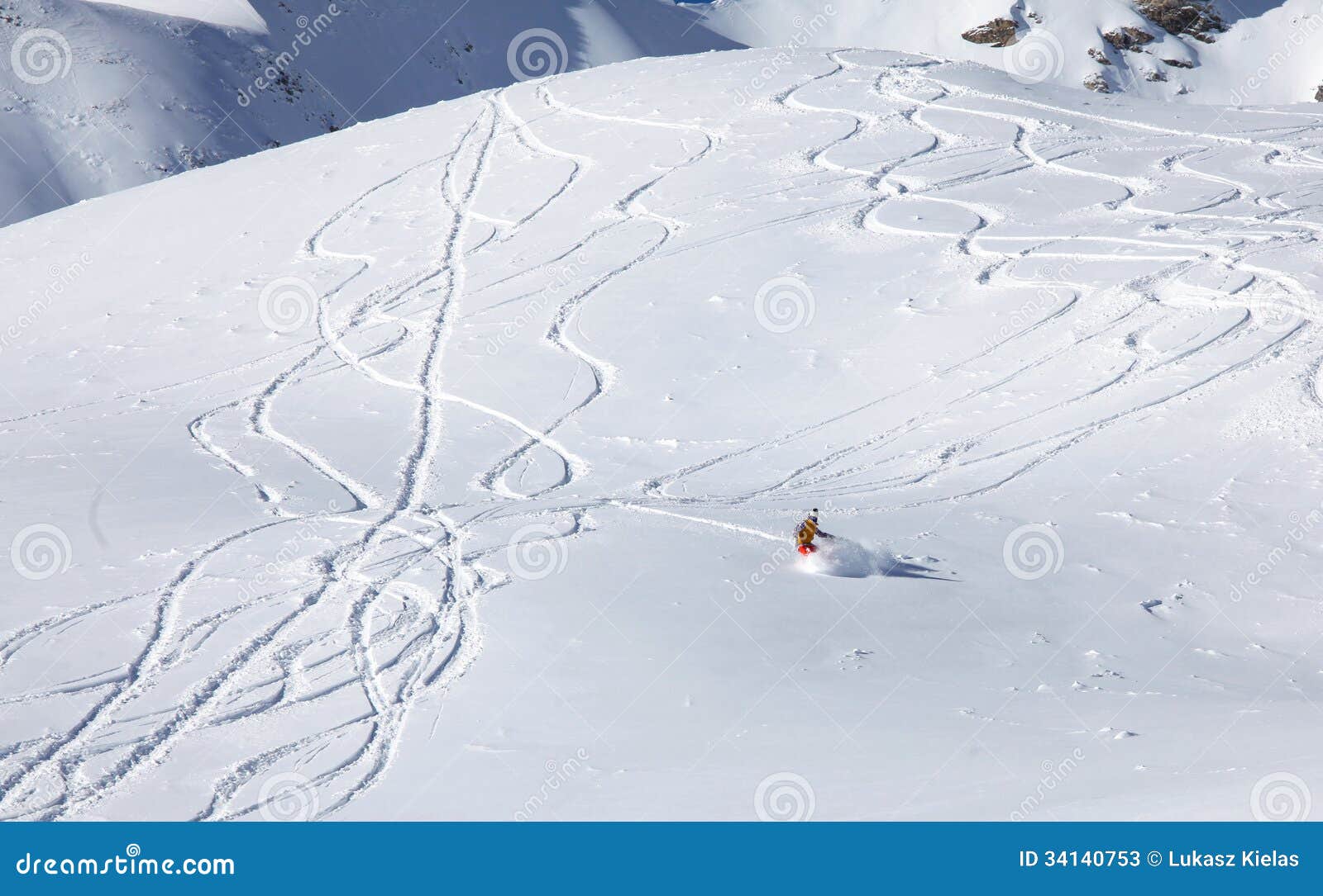 backcountry snowboarder riding fresh powder
