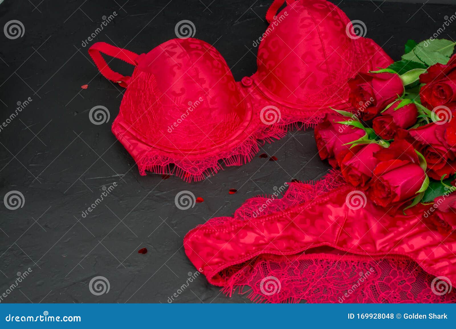 sexy black background with  knickers  bra and red roses