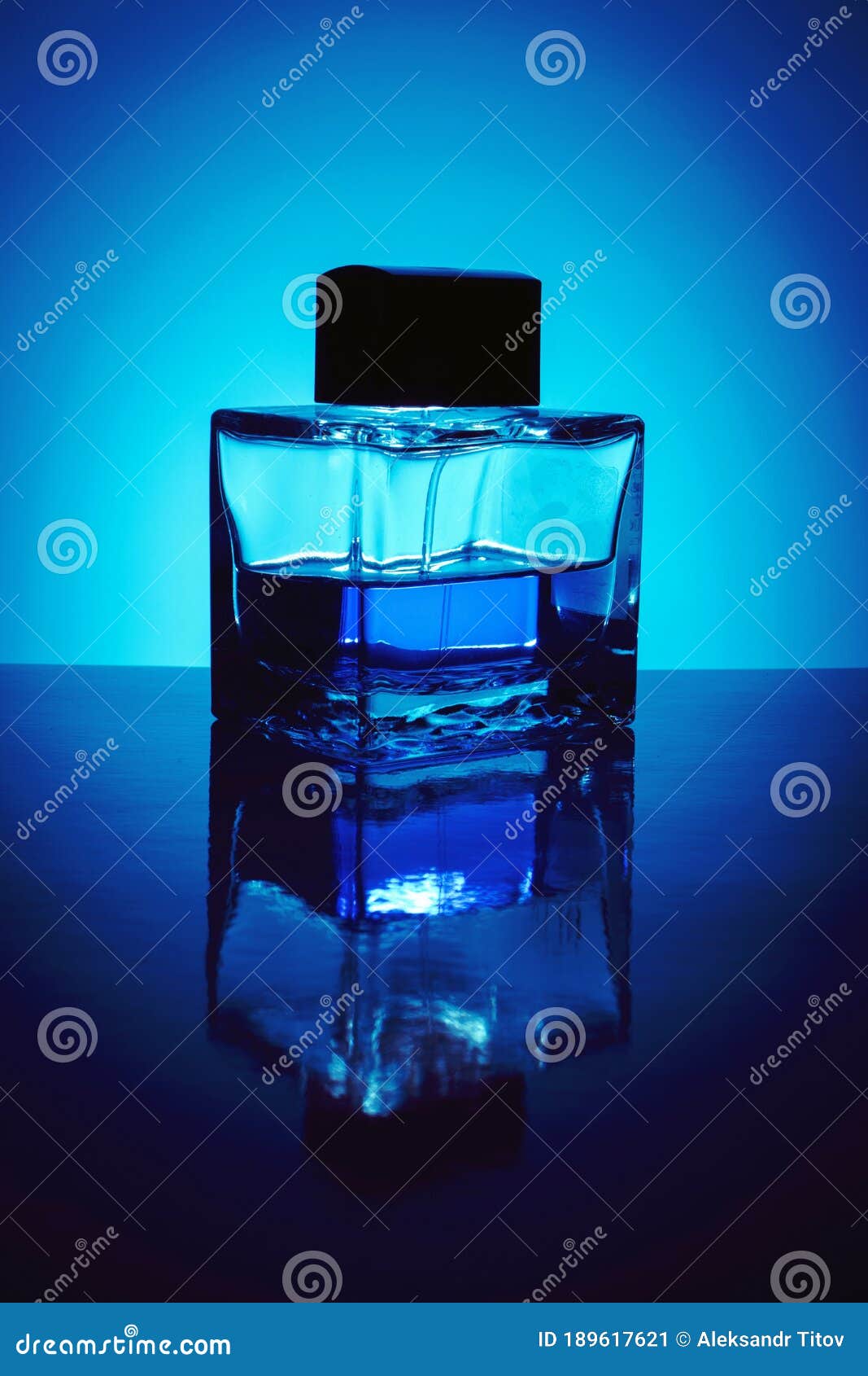 Background with Bottle of Perfume with Blue Liquid, Backlit. Stock
