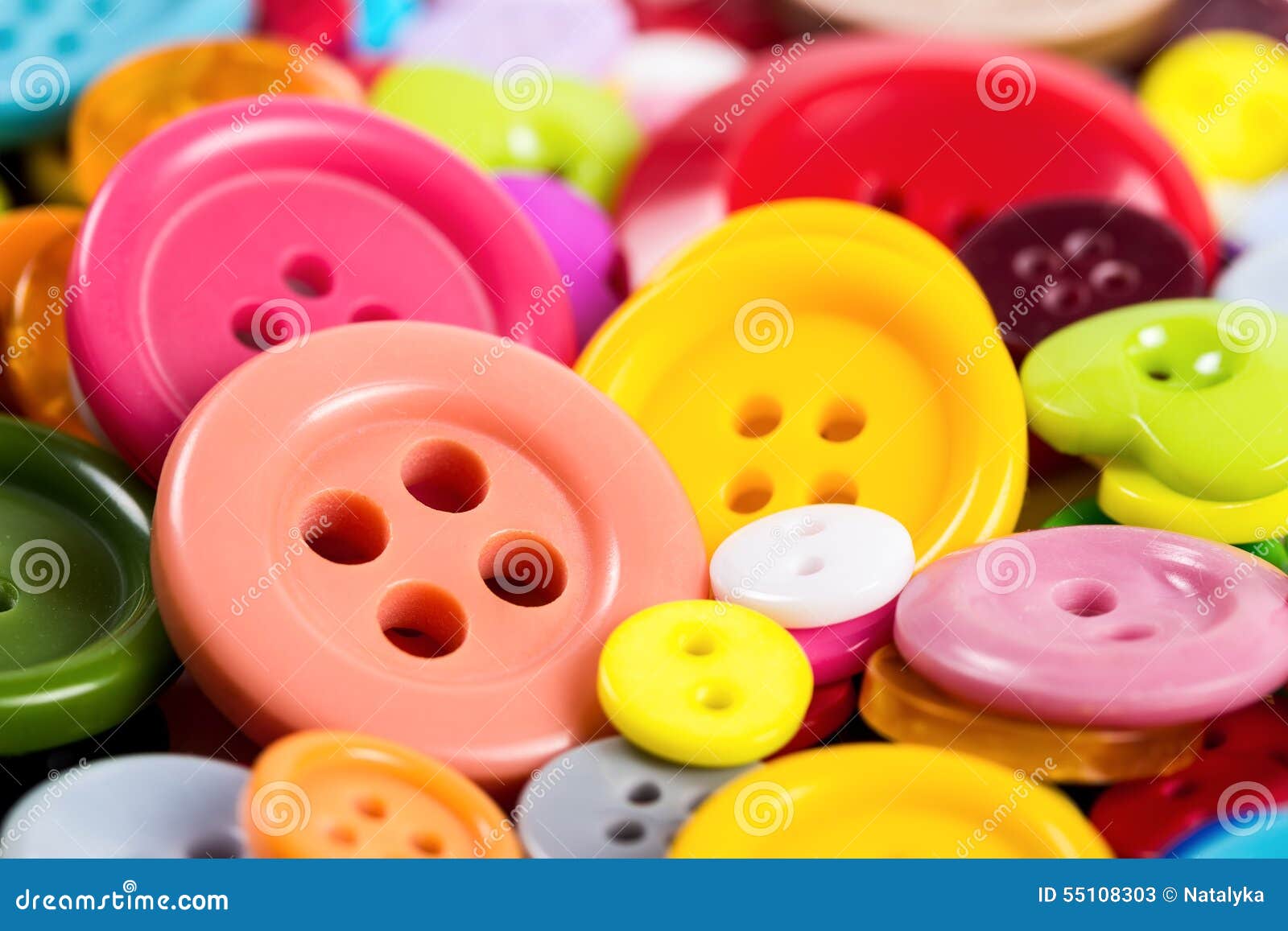 Background from of colorful buttons of different shapes, close-up.