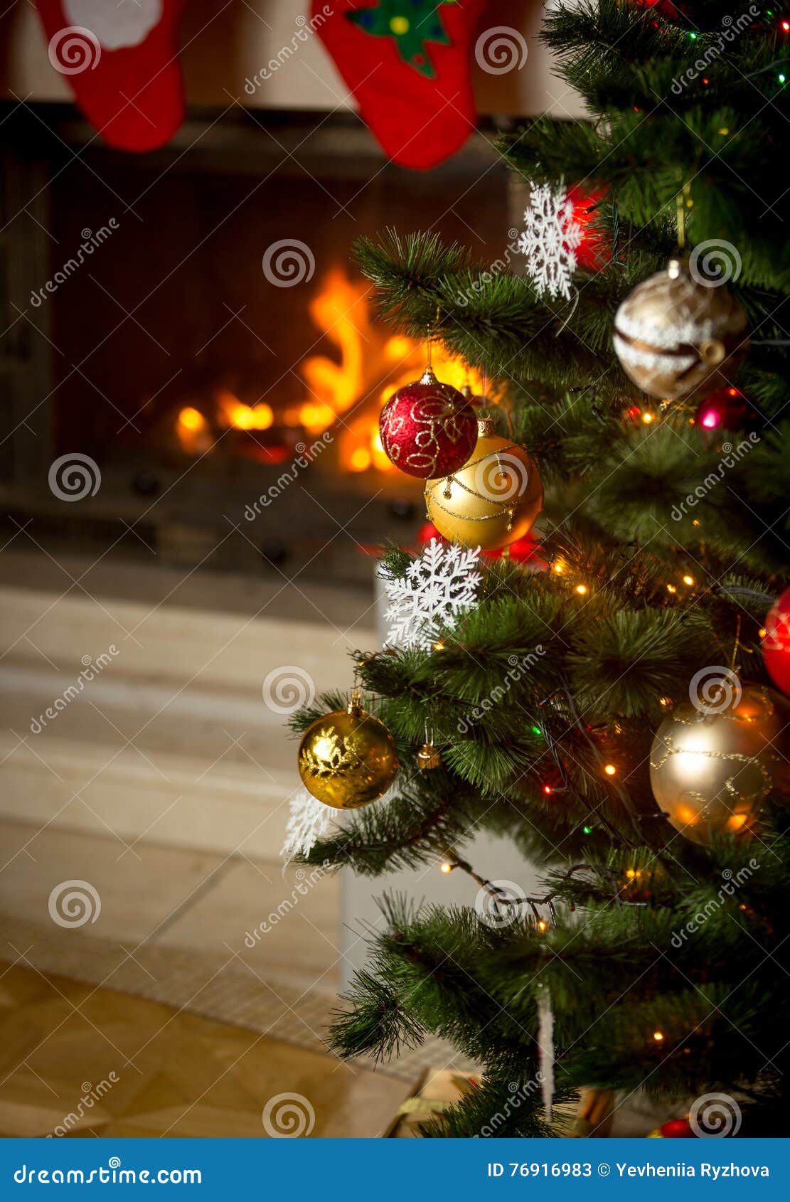Background of Decorated Christmas Tree in Front of Burning Fireplace at