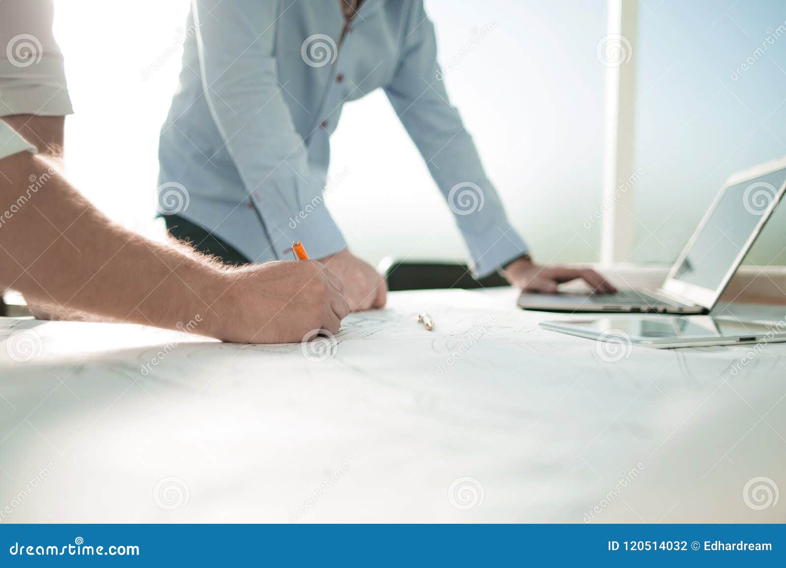 Background Image Of Architects Standing At The Desk Stock Photo