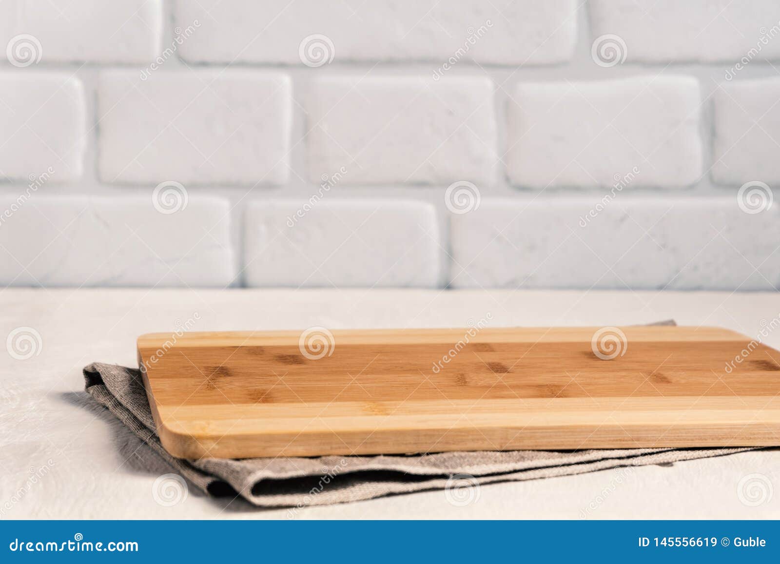 Background Kitchen With Cutting Board On White Wooden Table