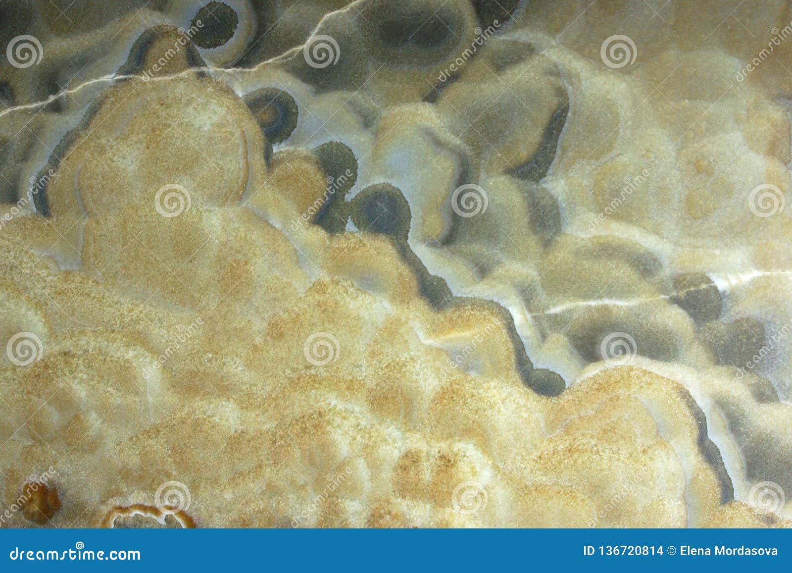 background from a light natural stone onyx with bubbles and gray stains on the surface, onix naranja veteado