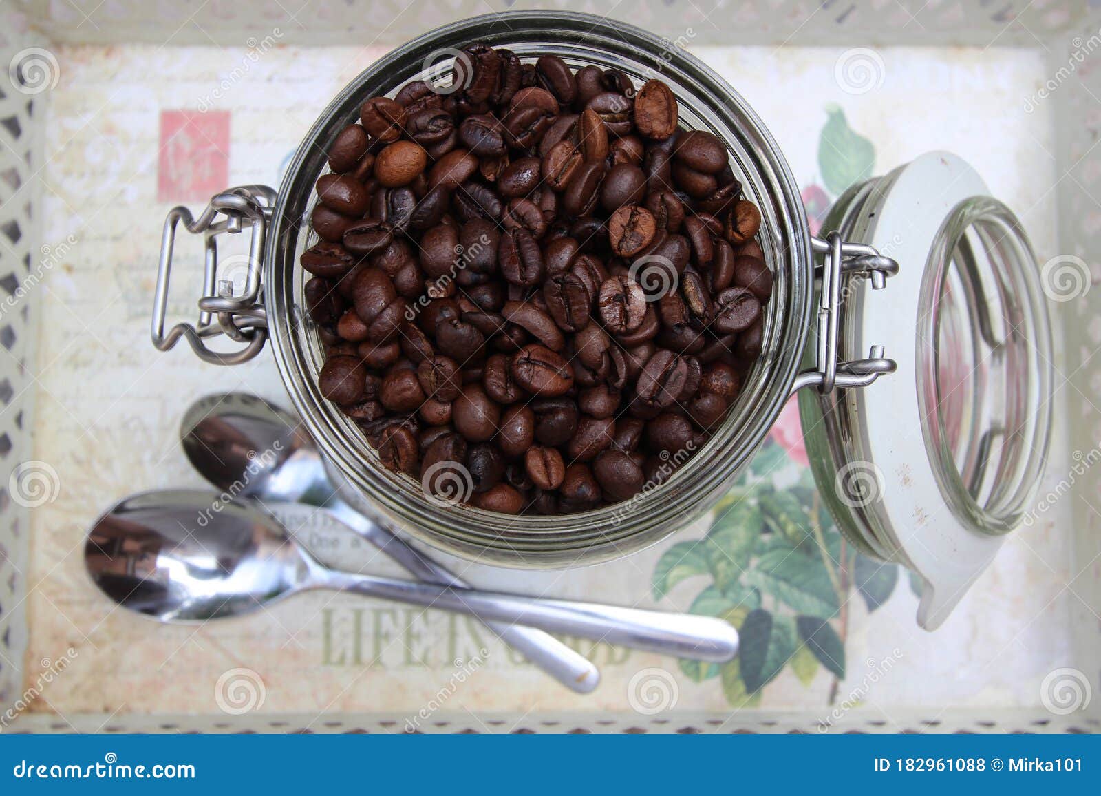 background with many small coffee beans in the jar