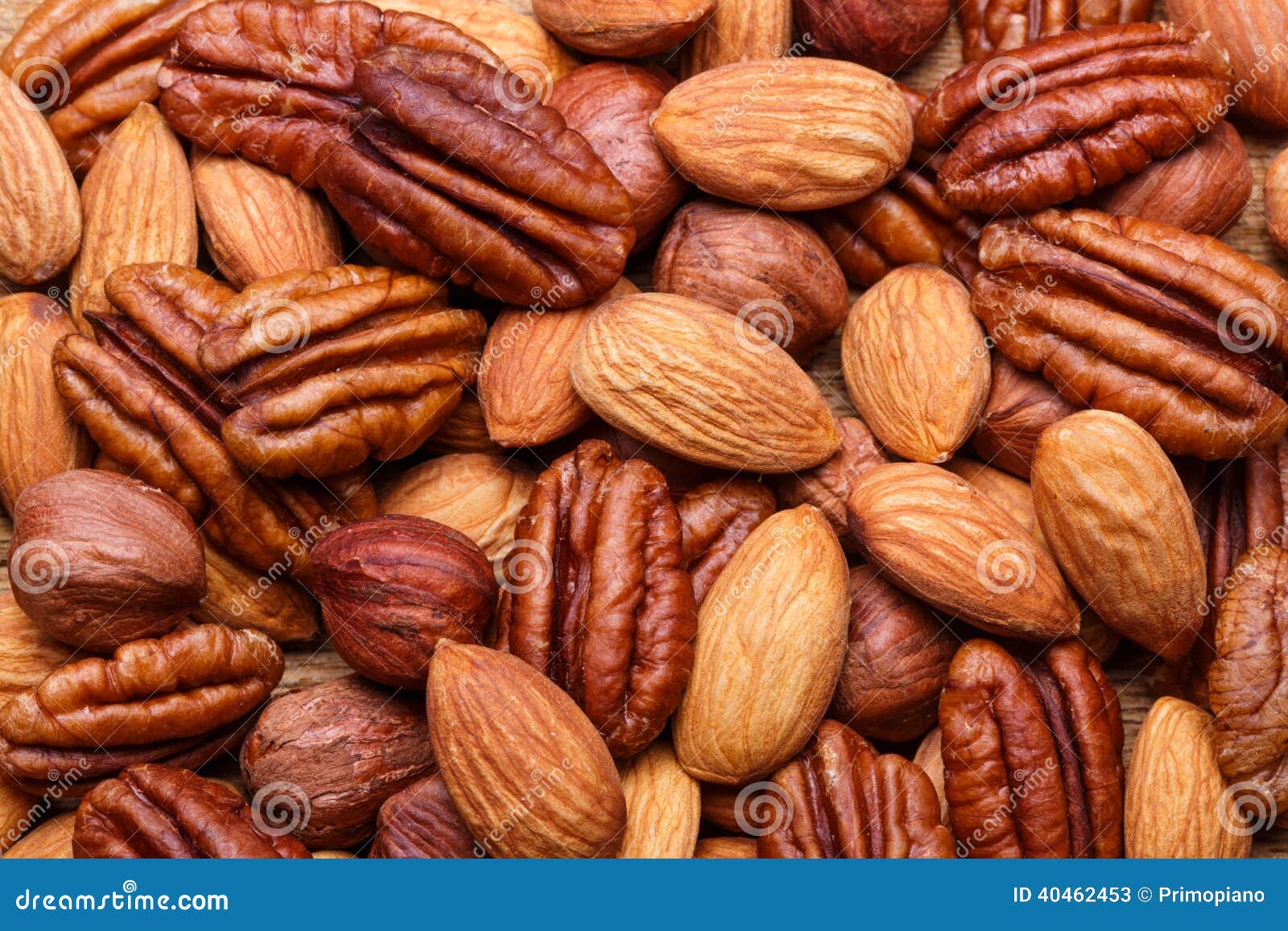 background texture of assorted mixed nuts including cashew, peca