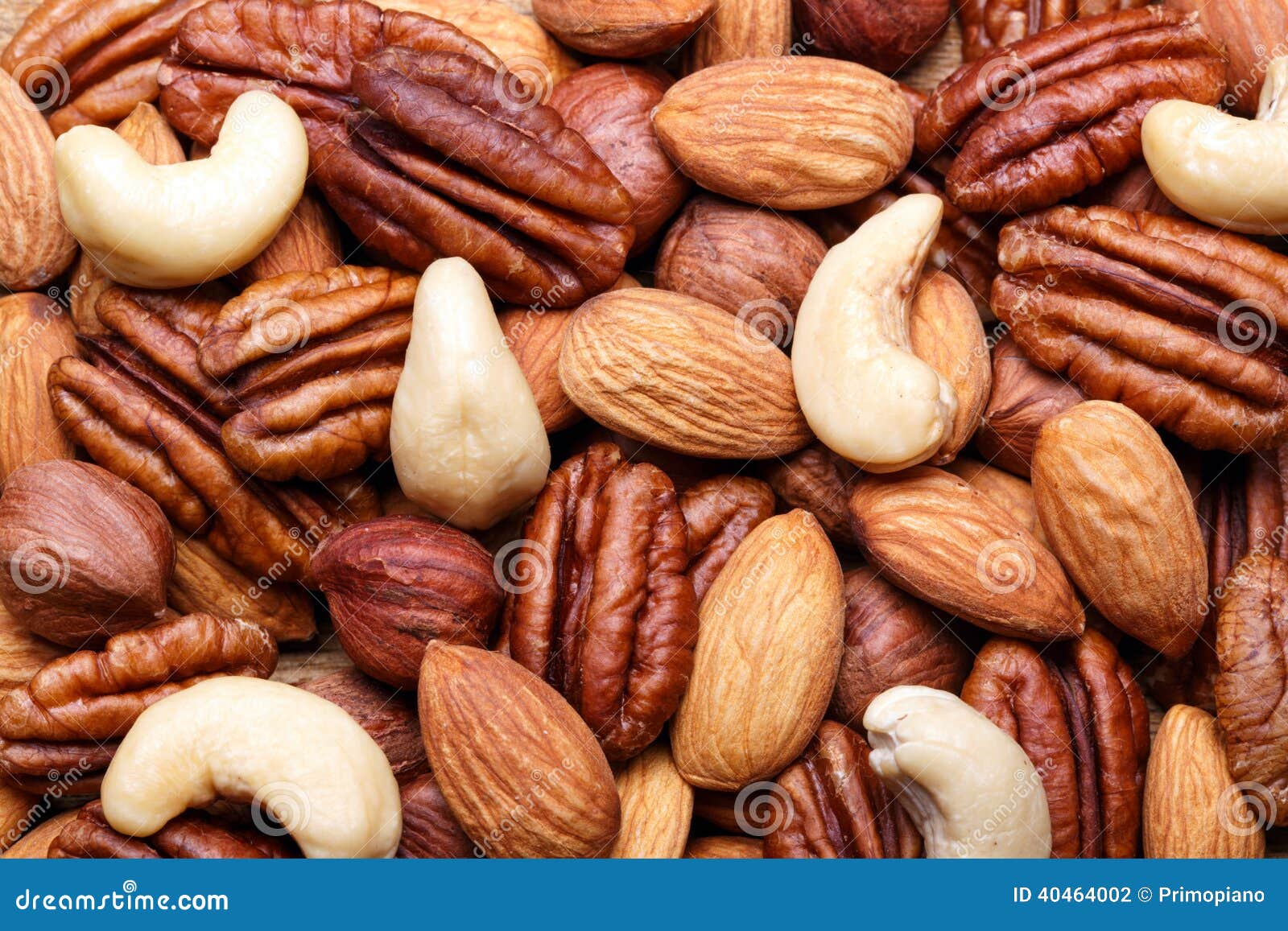 background texture of assorted mixed nuts including cashew, peca