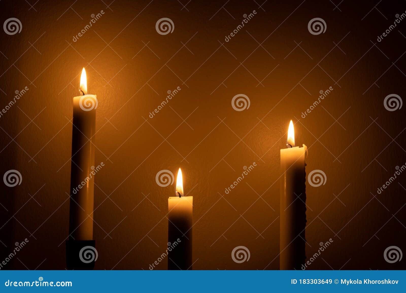 Large White Burning Candles in Dark Room Over Wall Background Stock ...