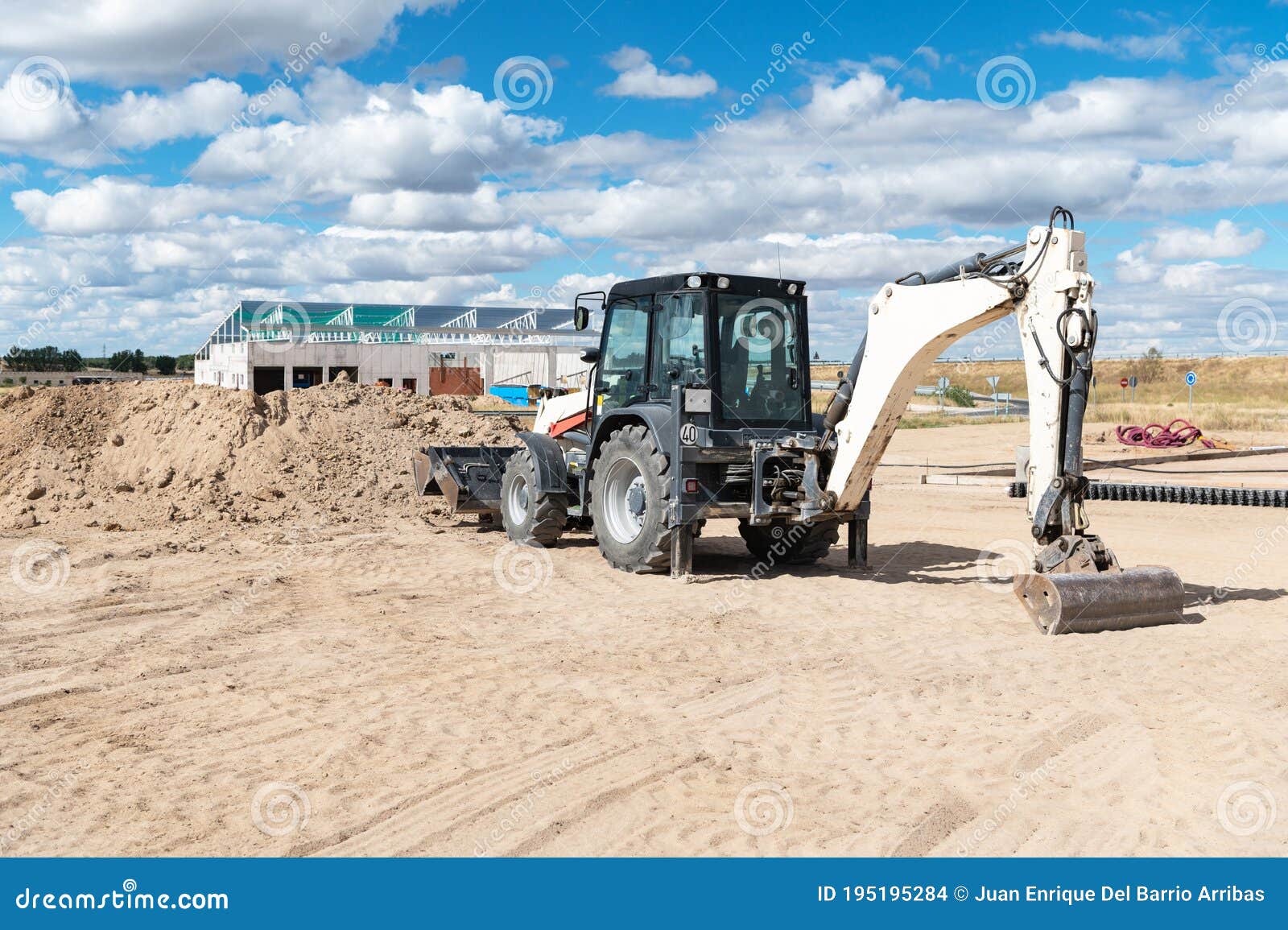 Backhoe Working at a Construction Site. Machinery with Two Blades Stock