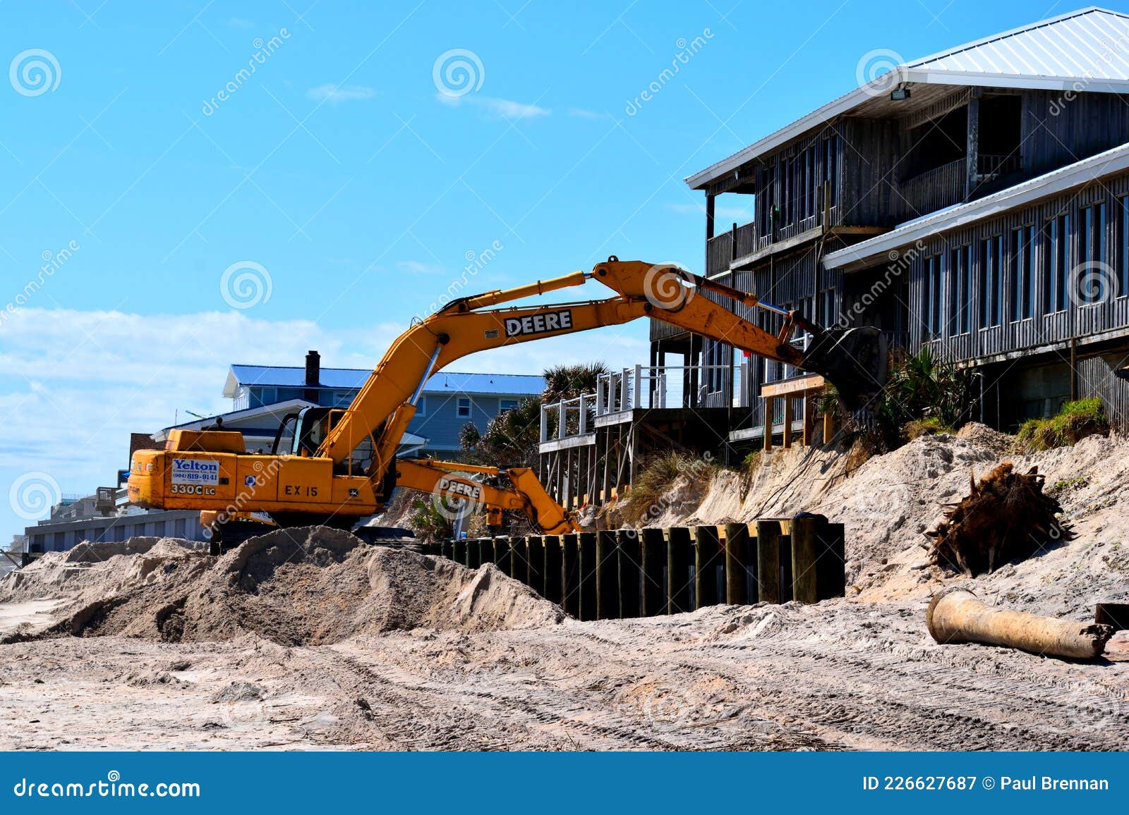 Backhoe Working at Fixing Beach Erosion. Editorial Photography Image