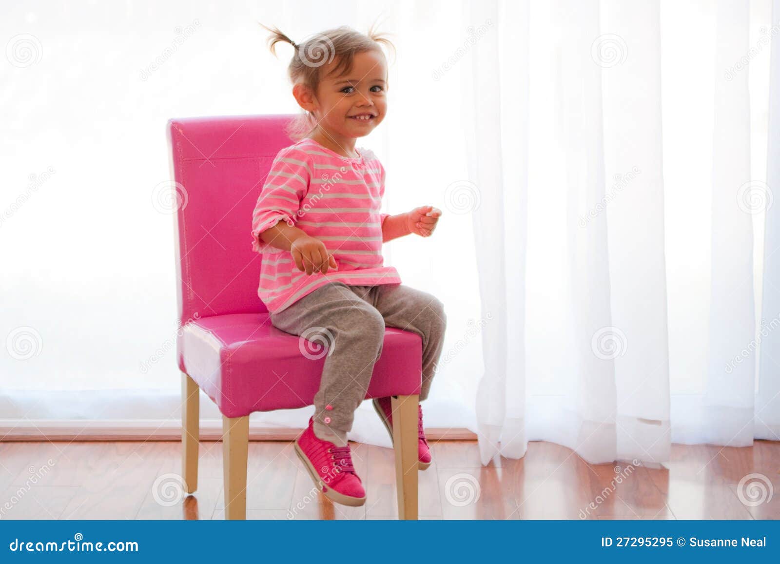 backlit toddler girl on pink chair