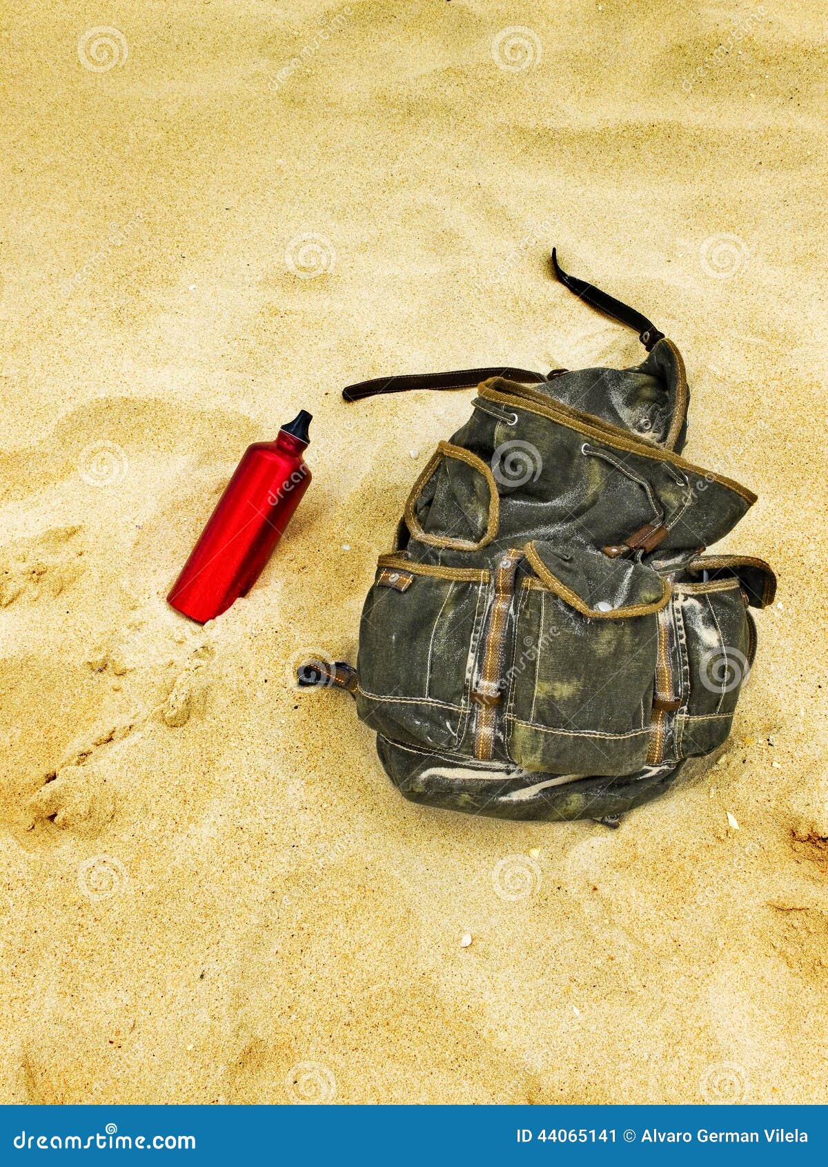 Backpack and Canteen Water Bottle in the Sand of a Beach. Stock Image Image of backpack