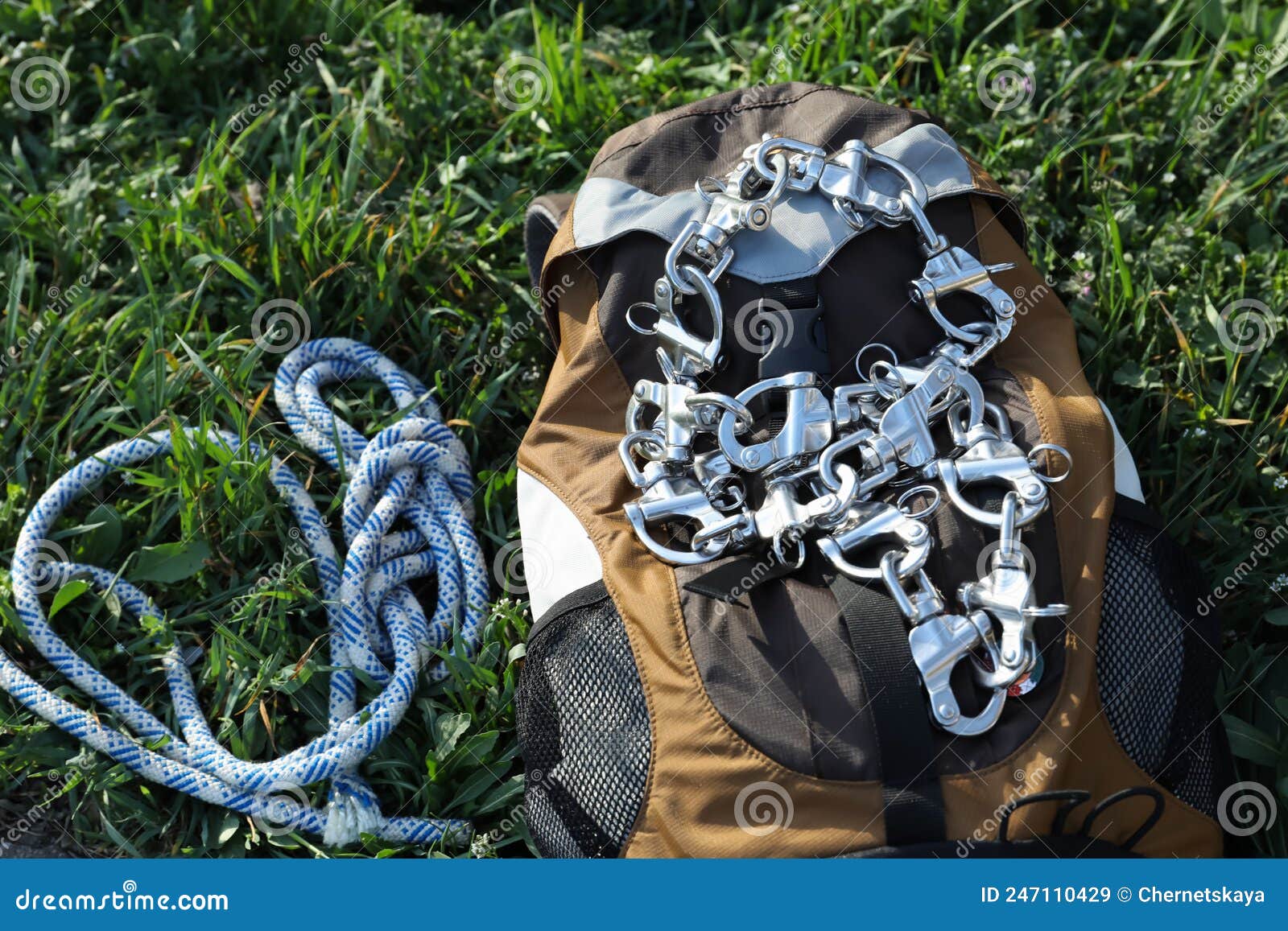 Backpack with Climbing Equipment on Green Grass Outdoors Stock Image