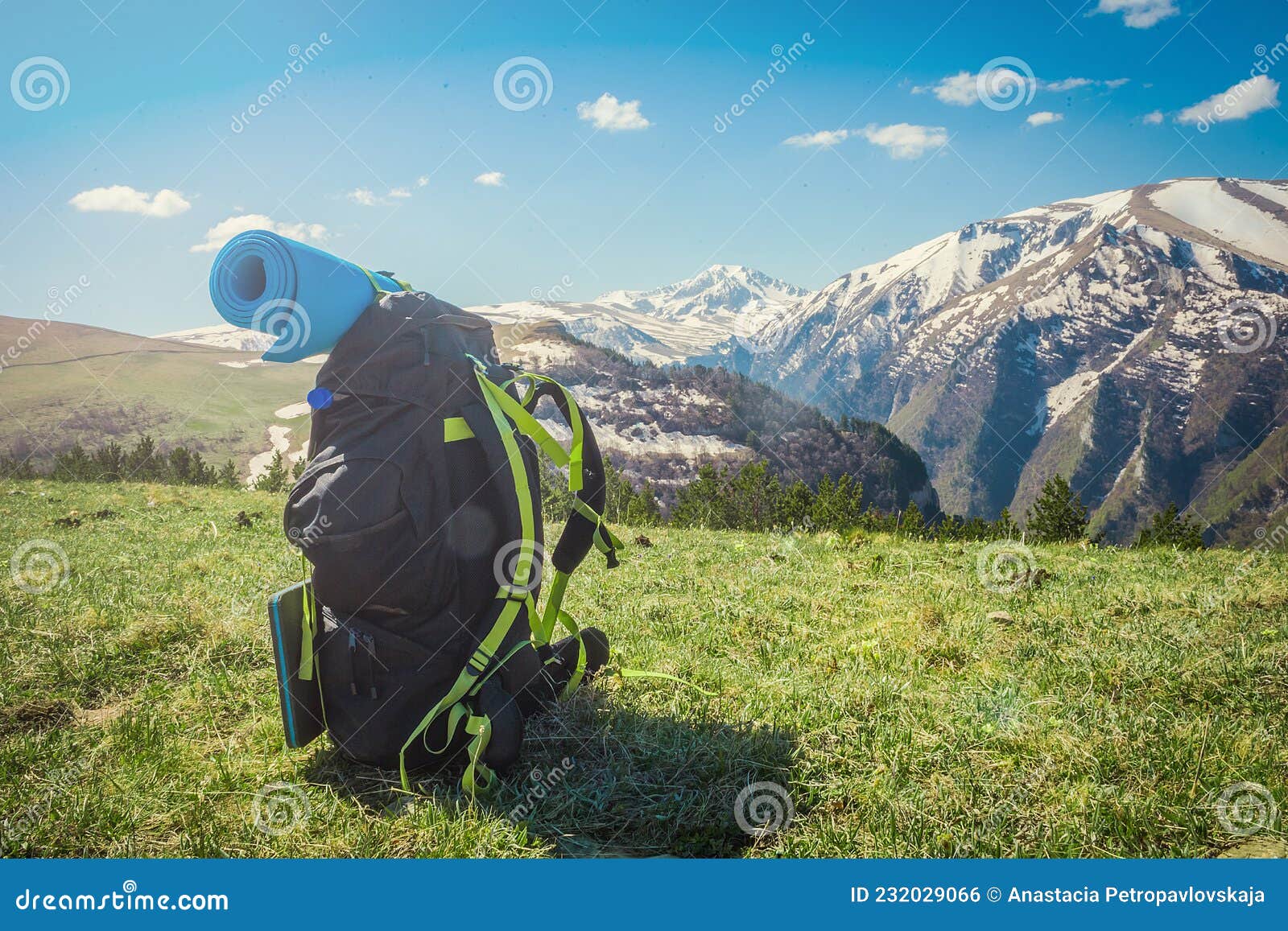 Backpack Stands on Top of a Beautiful Mountain, Hiking, Green Valley