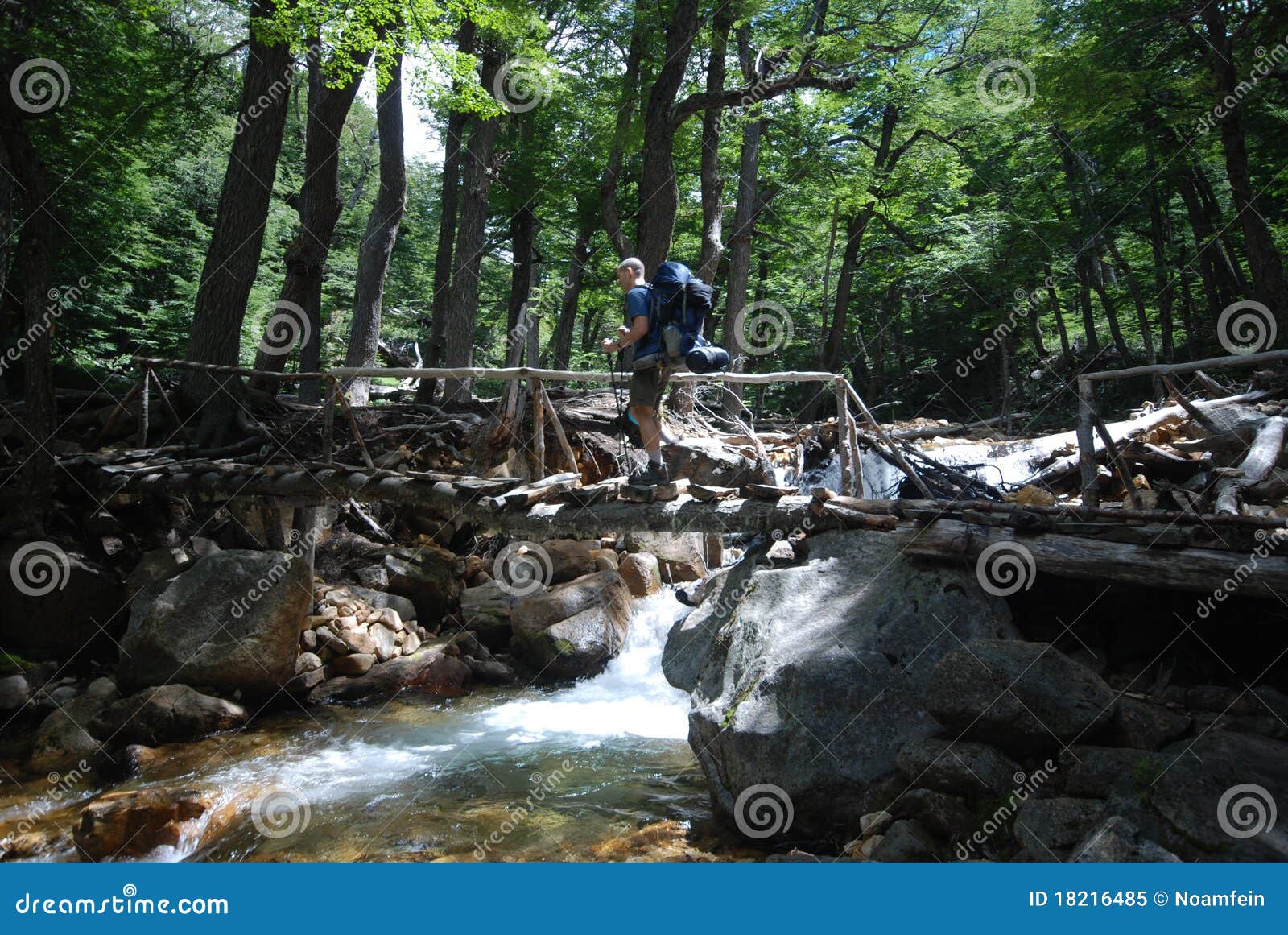 backpacker crossing a stream