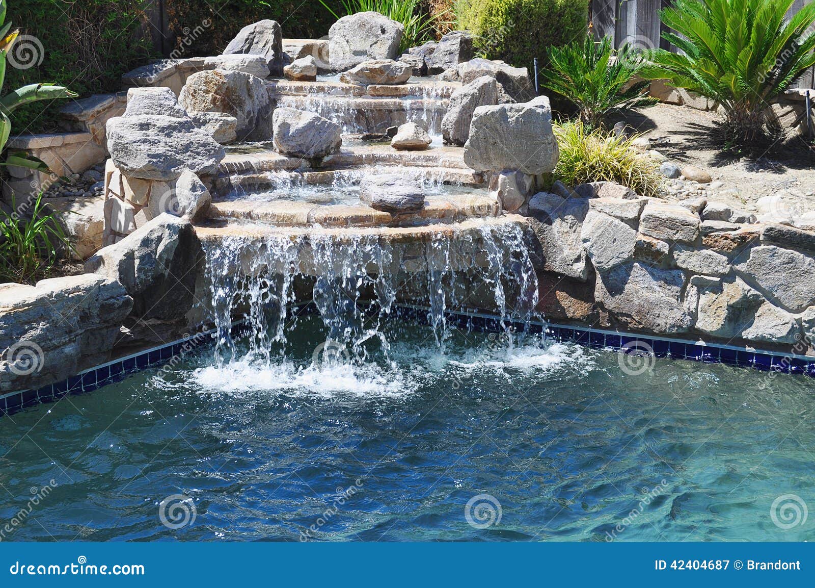 Build me a Jacuzzi with a Natural Stone Waterfall 💦 Imagine having  relaxing in this backyard all year round ☀️ Comment “BOOK” to start your  dream project 👇 #landscapedesign #outdoorlivingspace ..., image size:1600x1153