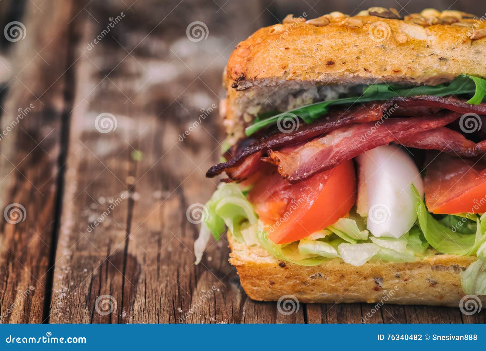 Bacon Baguette with Egg, Tomato and Lettuce. on an Old Wooden Table. Stock Photo Image of