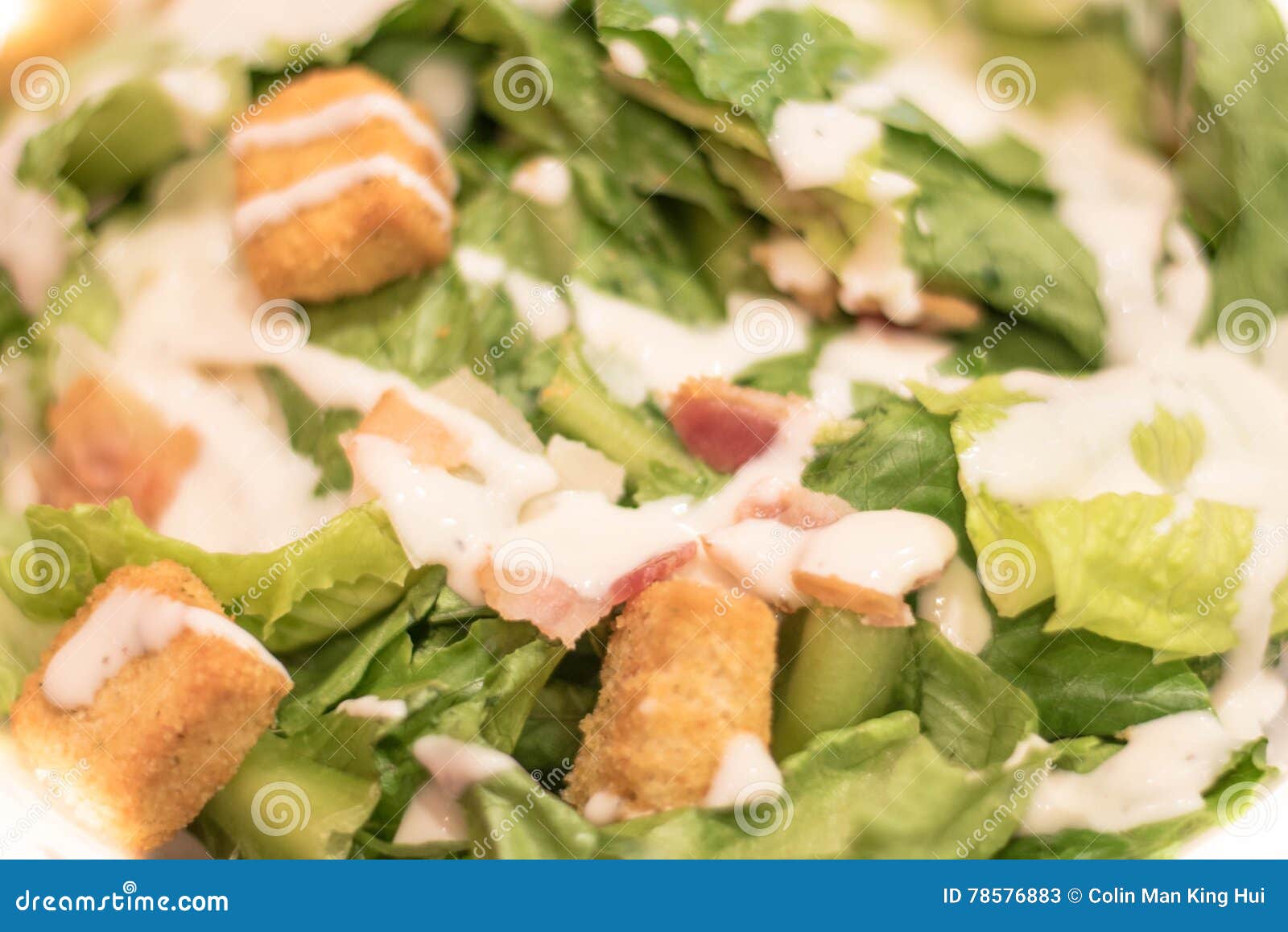 Bacon Caesar Salad with Shredded Parmeasan Cheese and Bread Cubes Stock