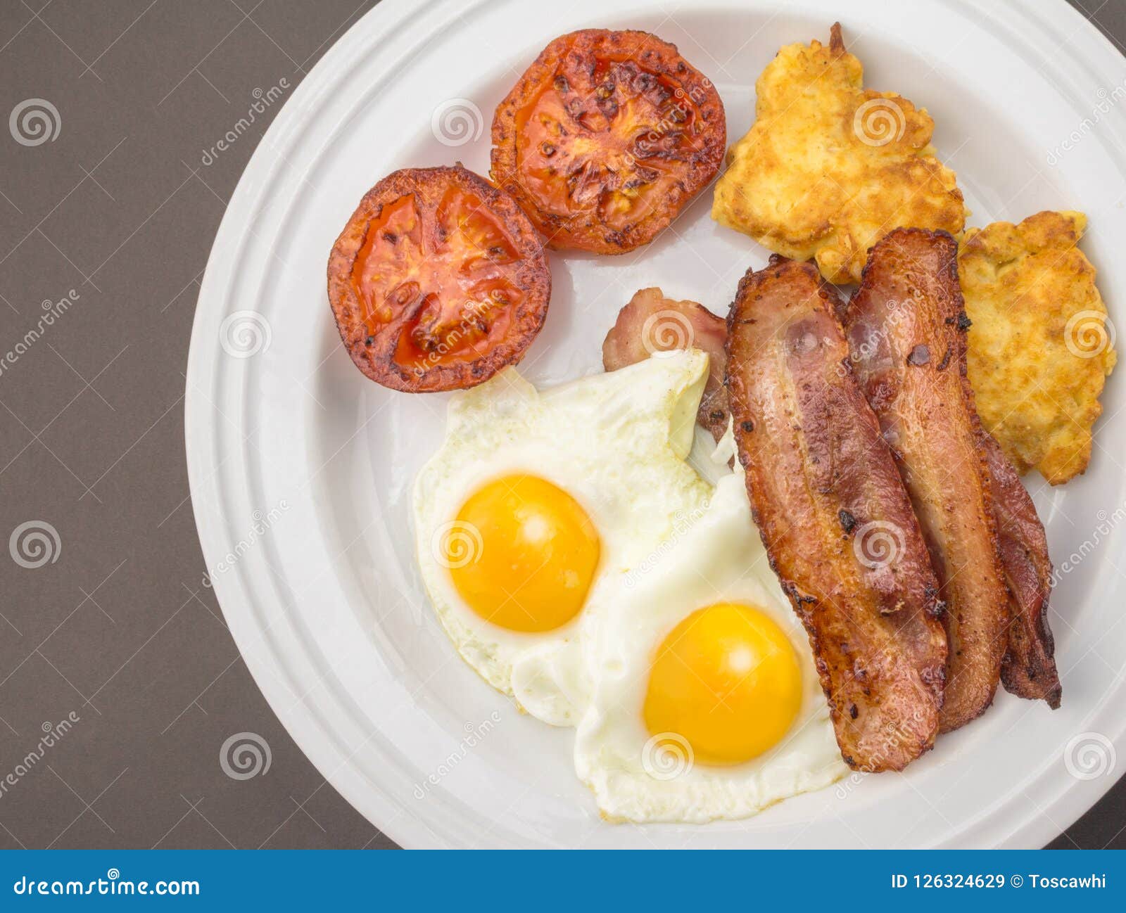 Bacon and Egg Breakfast with Hash Browns and Fried Tomato - Top Stock