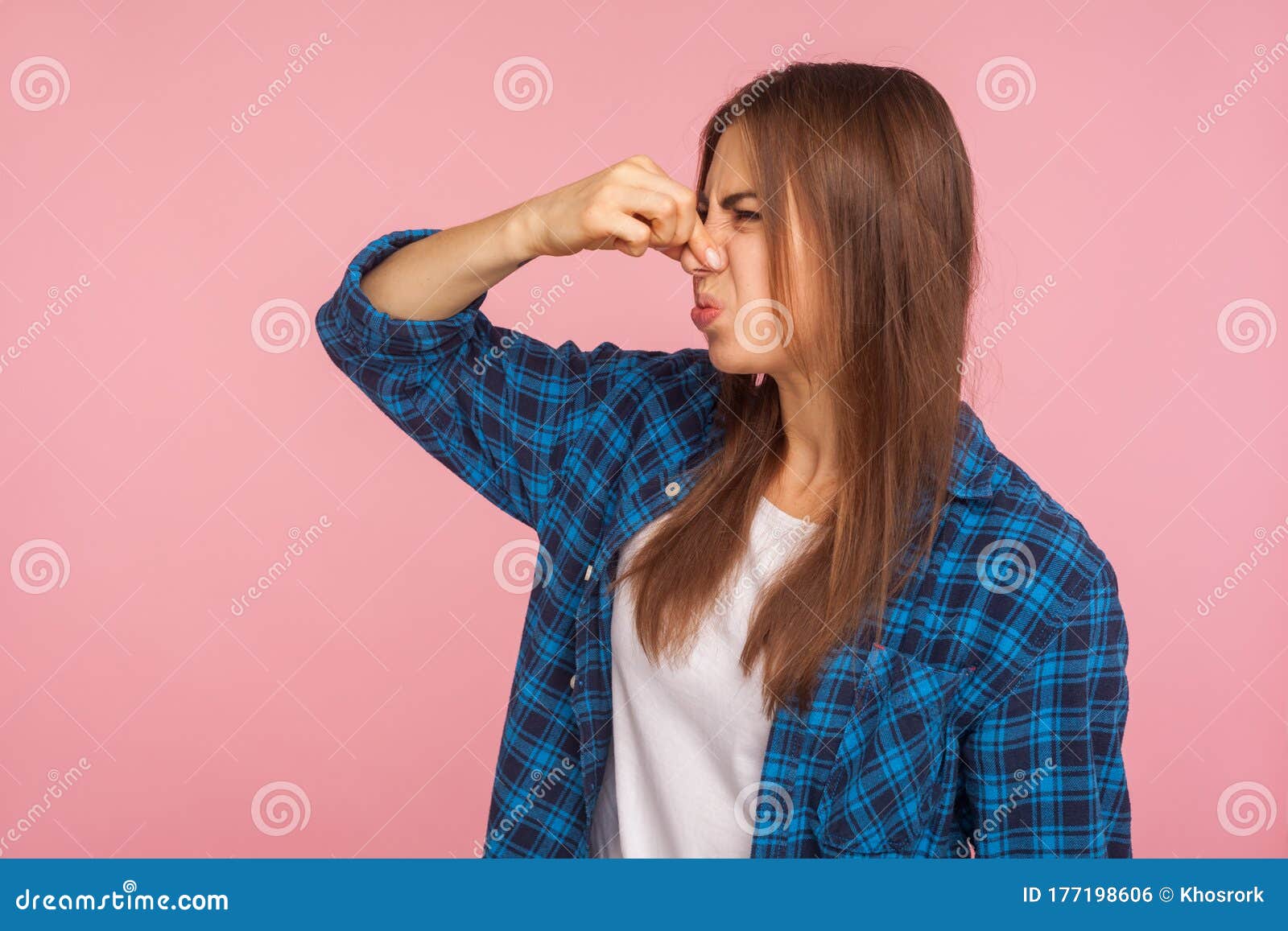 Unpleasant Smell Portrait Of Young Woman In Blue Dress Pinching Her