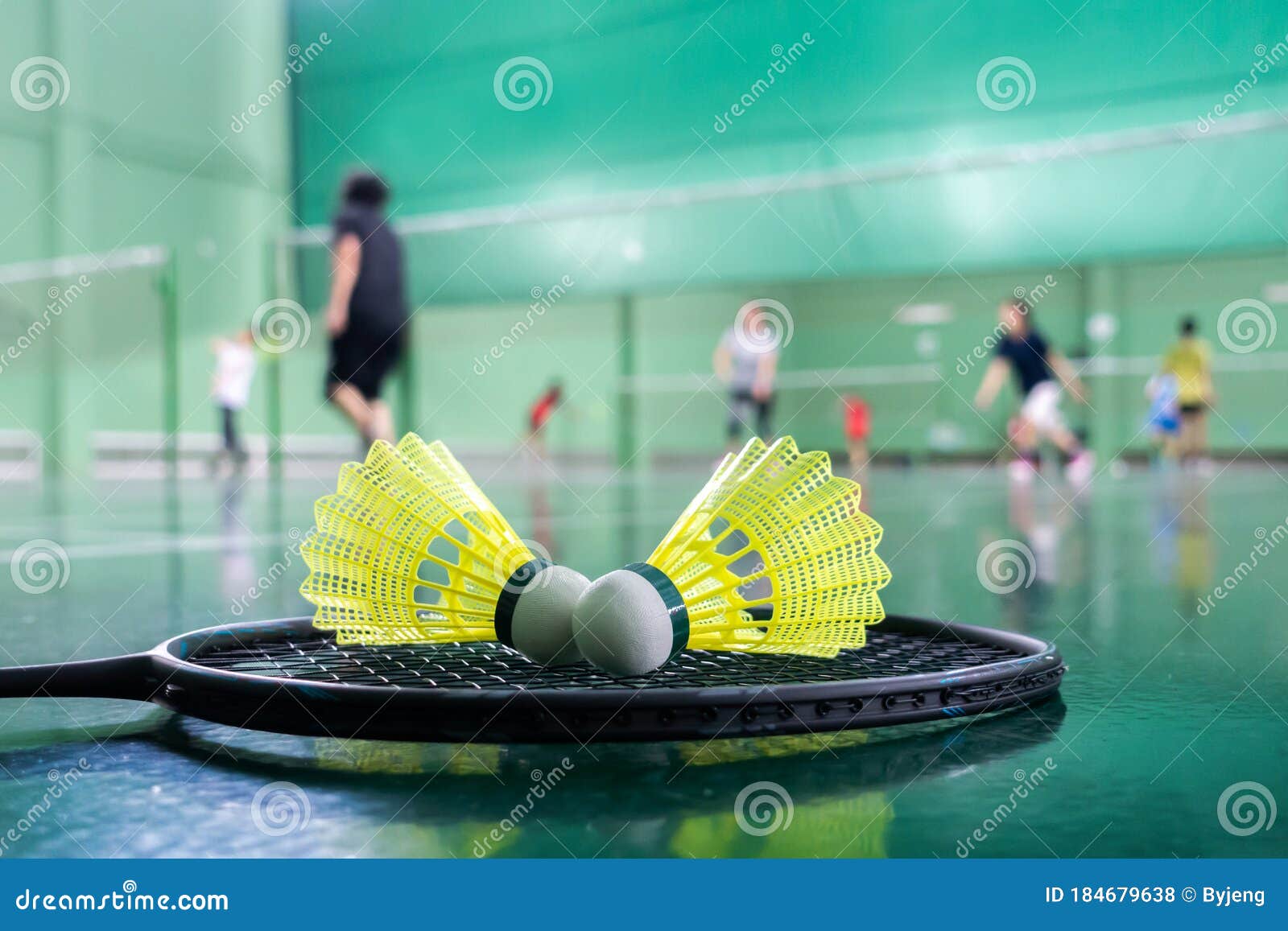 badminton courts with players competing